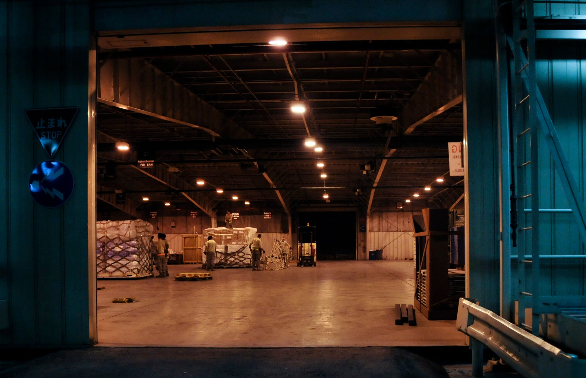 YOKOTA AIR BASE, Japan -- Airmen from the 374th Logistics Readiness Squadron and 730th Air Mobility Squadron pack and secure a pallet of relief supplies inside a cargo warehouse here March 20. The supplies will be delivered to Northern Japan to support Operation Tomodachi. (U.S. Air Force photo/Airman 1st Class Andrea Salazar)(Released)