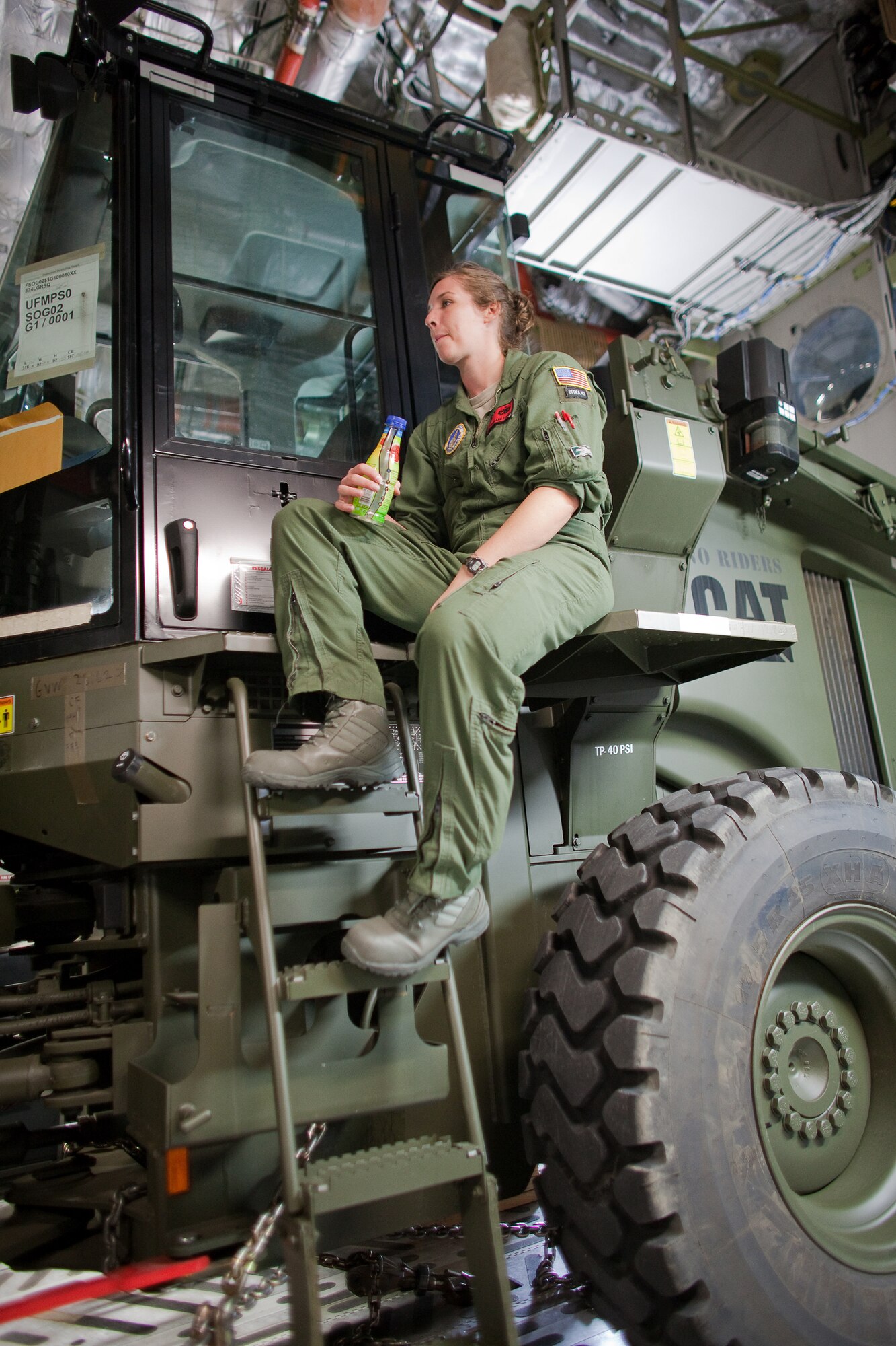 YOKOTA AIR BASE, Japan -- Staff Sgt. Carol Kemmis, 703th Aircraft Maintenance Squadron, waits to load another pallet inside a C-17 Globemaster III here March 20. This was the first C-17 carrying humanitarian relief supplies to land at Sendai Airport. (U.S. Air Force photo/Osakabe Yasuo)