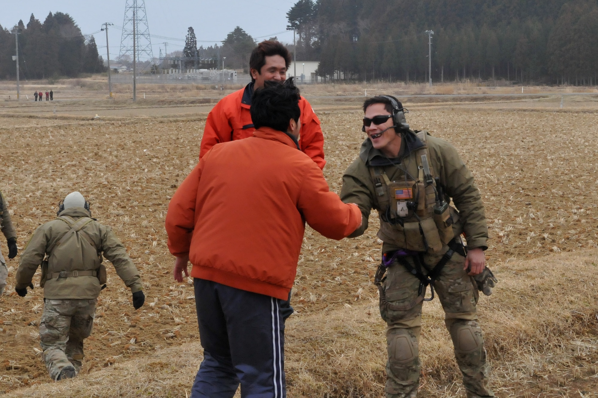 KESSENUMA CITY, Japan -- A Japanese relief worker shows his appreciation after a pair of HH-60s deliver food, water and medical supplies here March 20. The 33rd Rescue Squadron successfully transported supplies to displaced people in Kessenuma City, in support of Operation Tomodachi. Kessenuma experienced massive destruction from the earthquake and tsunami in northeastern Japan, March 11. (U.S. Air Force photo/2nd Lt. Christopher Love) 