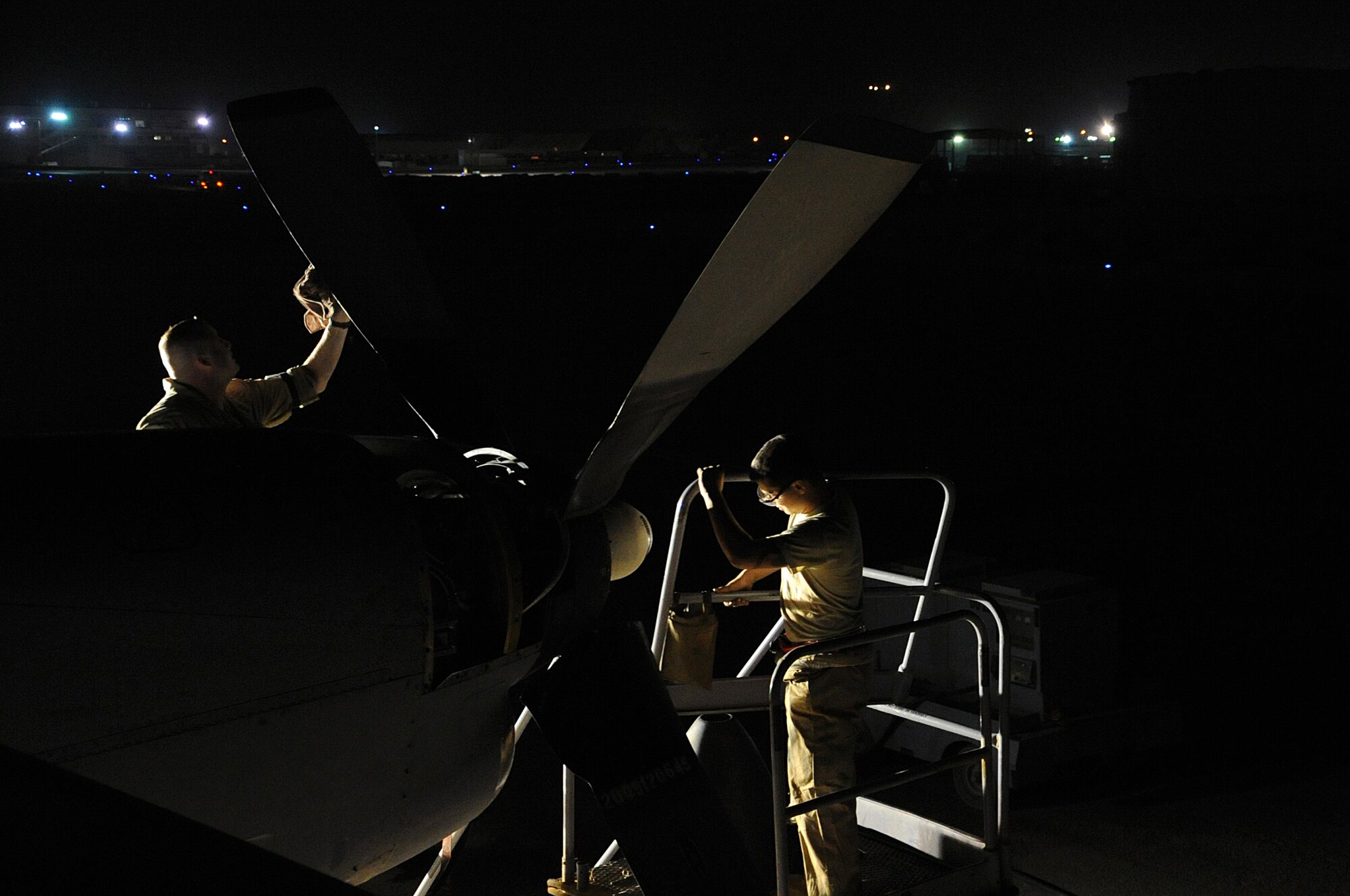 Tech. Sgt. Chris Ferreira and Airman 1st Class James Eller prep a propeller for final installation during night-time maintenance work on a C-130 Hercules March 1. Both are jet propulsion specialists with the 386th Expeditionary Maintenance Group. (U.S. Air Force photo by Senior Airman Cynthia Spalding)