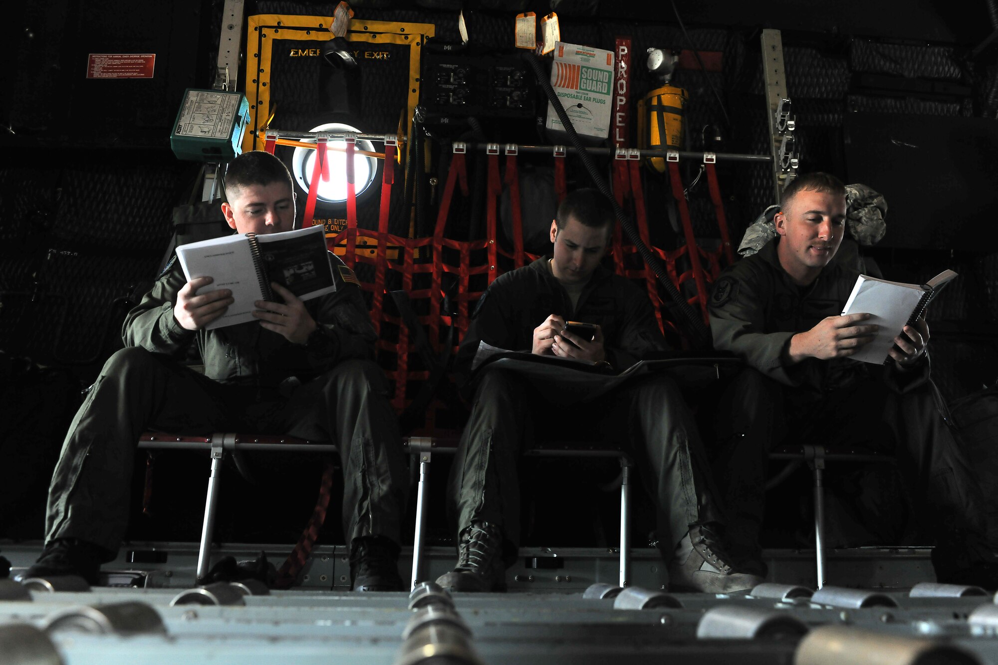 YOKOTA AIR BASE, Japan -- Senior Airman J.T. Mills (left), Staff Sgt. Nick Wisnoski, and Capt Daniel Gipper, 17th Special Operations Squadron, Kadena Air Base, Japan, check over their flight manuals for their MC-130 before departing on a flight from Yokota March 19. The 17th SOS is flying missions in support of Operation Tomodachi. (U.S. Air Force photo by/ Master Sgt. Jeromy K. Cross)









