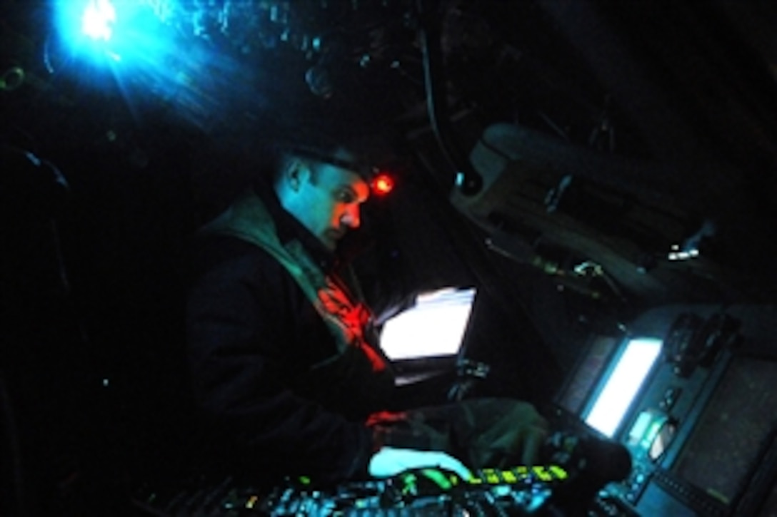 U.S. Navy Petty Officer 2nd Class Joseph Fremen calibrates the forward-looking infrared system of a MH-60S Knight Hawk helicopter on the flight deck of amphibious assault ship USS Kearsarge to support Operation Odyssey Dawn in the Mediterranean Sea, March 19, 2011. The infrared system allows pilots a 360-degree view of the area surrounding the helicopter. Fremen is assigned to Helicopter Sea Combat Squadron 22.