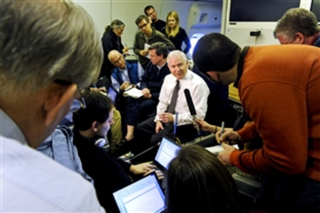 Defense Secretary Robert M. Gates, center, speaks to reporters en route to Russia, March 20, 2011. Gates plans to meet with Russian officials to discuss defense reforms under way in both nations, global security and arms-control issues.
