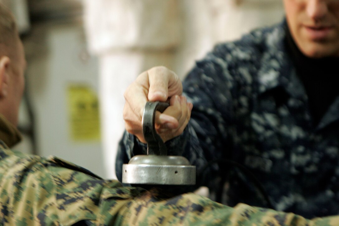 A radiological control technician inspects a Marine of the 31st Marine Expeditionary Unit returning from an aid mission to Japan for possible low-level radioactive contamination, March 21. The team was brought in to aid the USS Essex and the 31st MEU during Operation Tomodachi, as Marines and Sailors deliver humanitarian aid and disaster relief supplies to areas of Japan. Navy and Marine Corps involvement is part of a larger U.S. government response, coordinated through the U.S. Department of State, after a 9.0 earthquake and subsequent tsunami struck Japan causing widespread damage. The 31st MEU is ready to support our Japanese partners and to provide assistance when called upon.