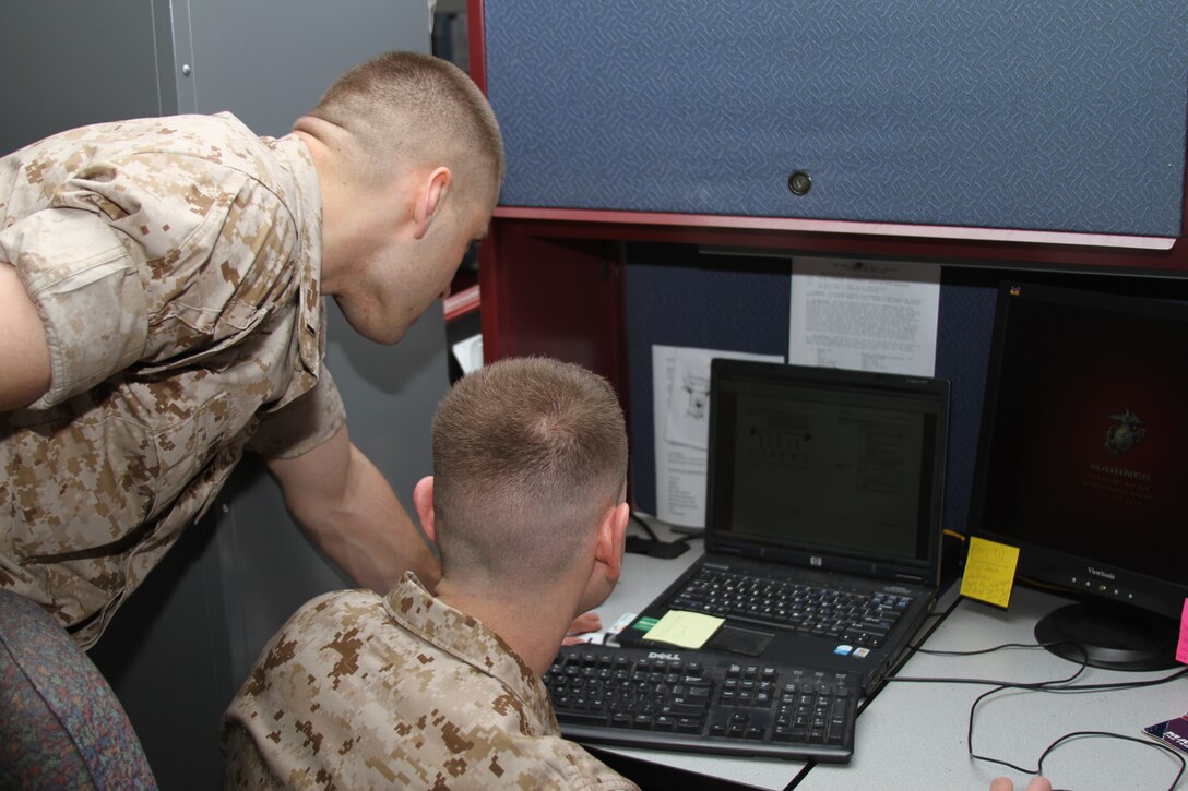 Second Lt.’s Andrew Fink, assistant student judge advocate, and Steven Kasdan, project officer, MCRC, take a time out to study The Basic School knowledge. Reading required material before going to TBS will put Fink and Kasdan ahead of the learning curve when they check in for the six months of training in June.