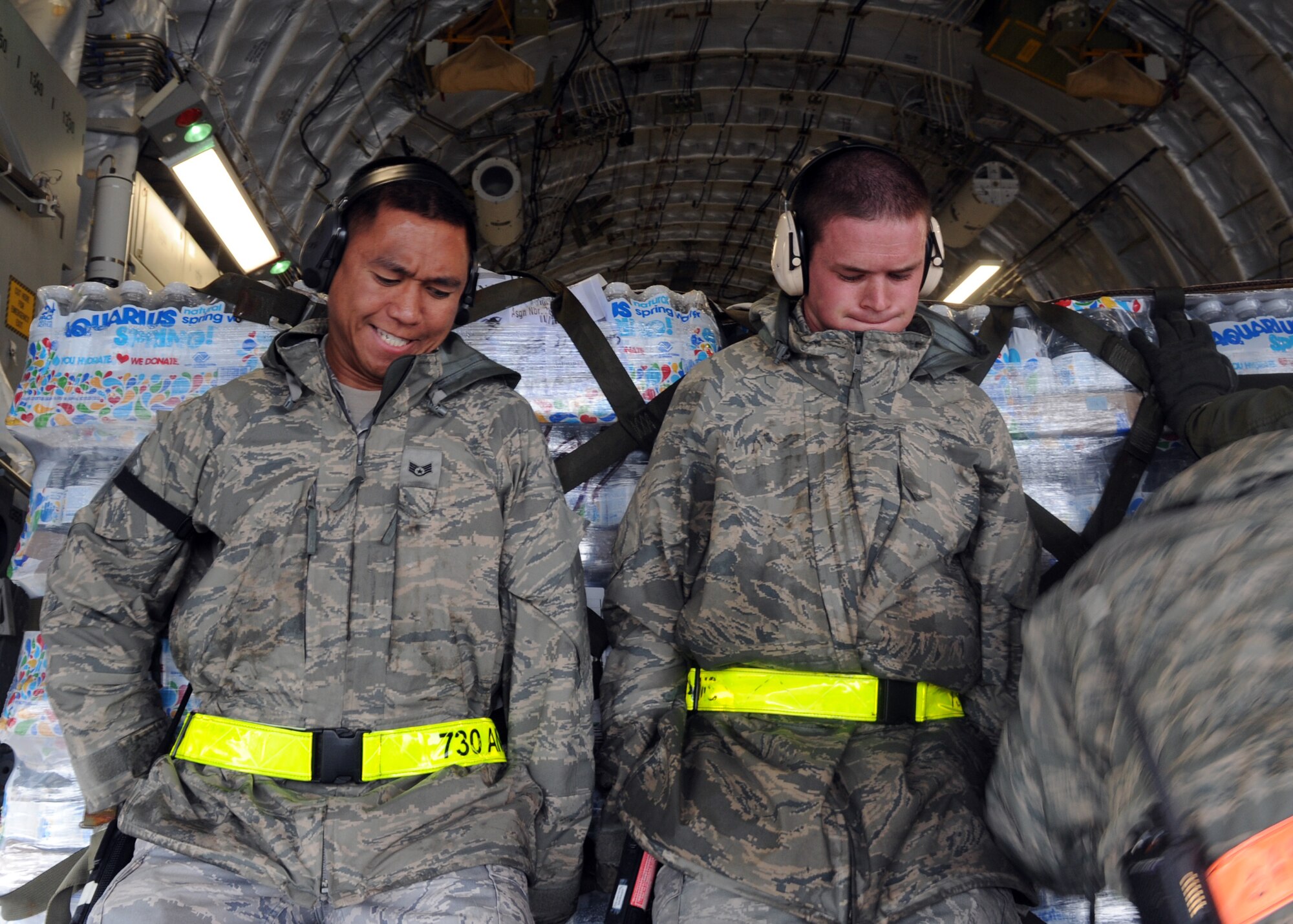 YOKOTA AIR BASE, Japan -- Staff Sgt. Nathaniel Olaguer (left) and Airman 1st Class Patrick Springsteen push a pallet of water on to a C-17 Globemaster III from Royal Australian Air Force Base Amberley March 21. With the assistance of Yokota Airmen, the RAAF delivered 16 pallets of humanitarian aid to Sendai, Japan, in support of Operation Tomodachi. Operation Tomodachi is a relief support mission aiding those affected by the devastation caused by the recent earthquake and tsunami March 11. Sergeant Olaguer and Airman Springsteen are assigned to the 730th Air Mobility Squadron. (U.S. Air Force photo/Senior Airman Michael J. Veloz)