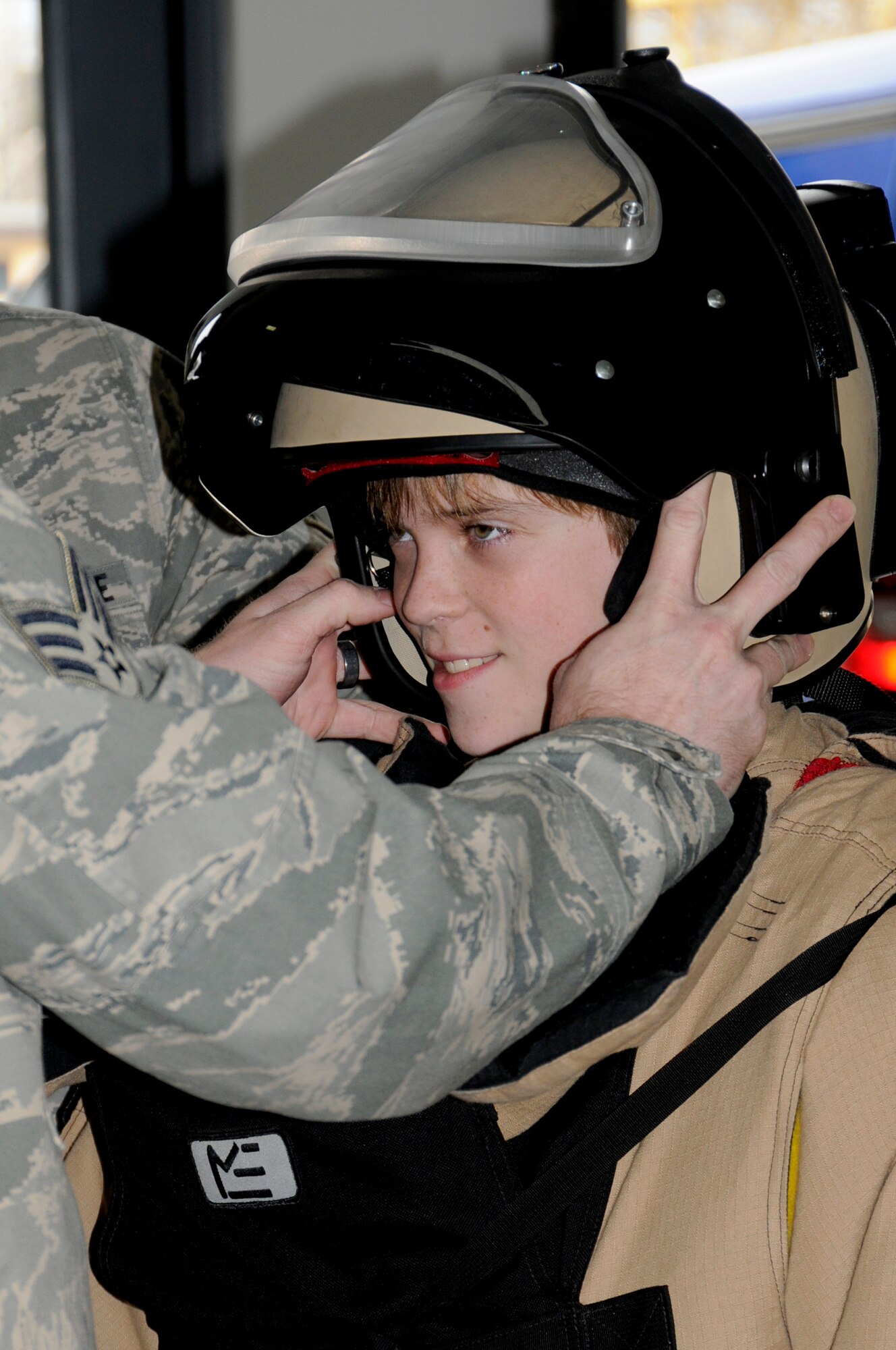 Hunter Bozaich tries on an Explosive Ordnance Disposal suit during his visit for the Pilot for a Day program, March 21, 2011 at Scott Air Force Base, Ill. Hunter, who is diagnosed with Cystic Fibrosis was nominated by Cardinal Glennon Children's Medical Center to come to Scott and be a pilot for a day. His day consisted of multiple events and tours to include a C-40 Static, a military working dog demonstration, tower tour, and a ride in a flight simulator. (U.S. Air Force photo/Staff Sgt. Brian J. Valencia)