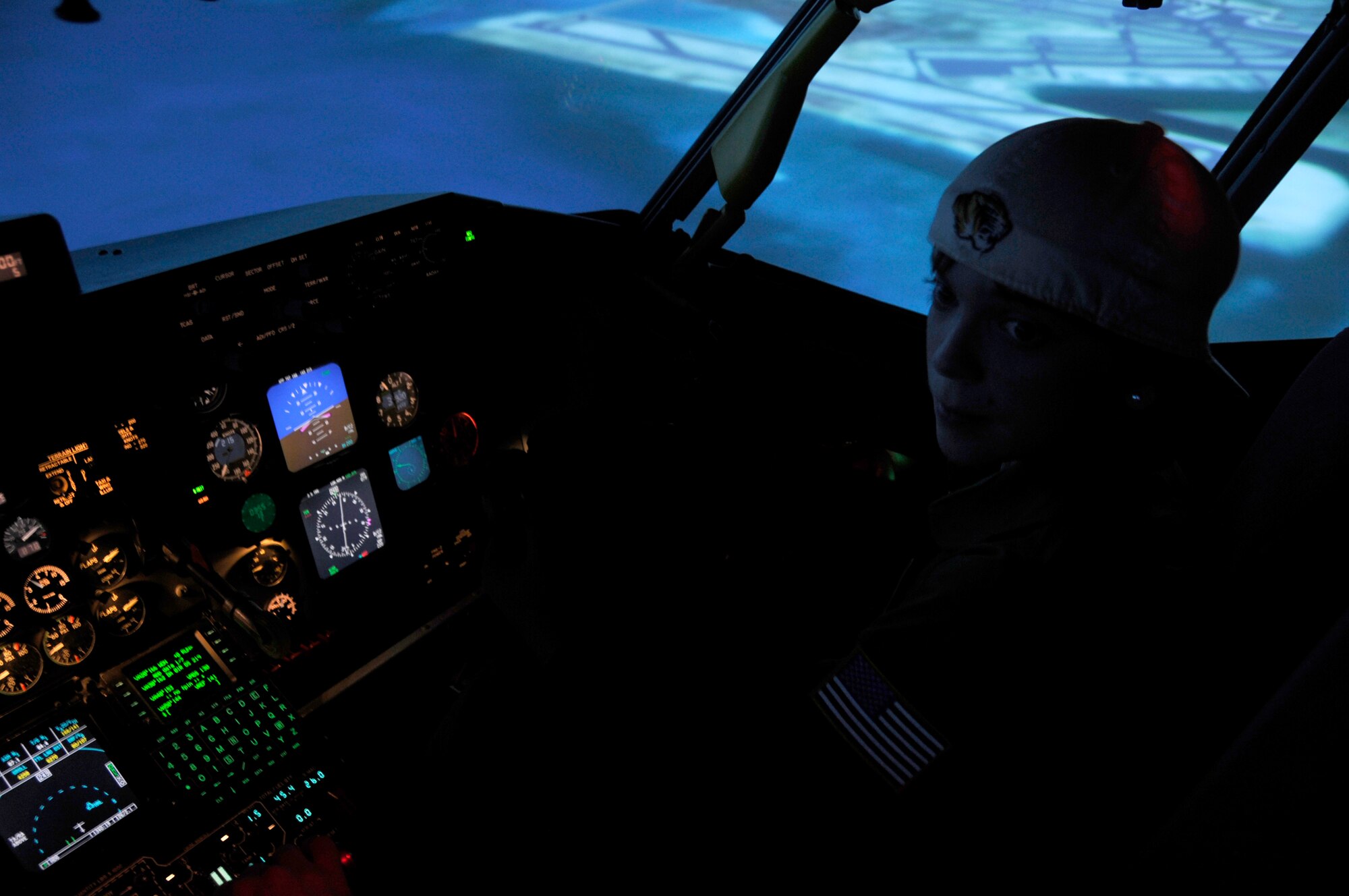 Hunter Bozaich prepares to take control of a KC-135 simulator during his visit for the Pilot for a Day program, March 21, 2011 at Scott Air Force Base, Ill. Hunter, who is diagnosed with Cystic Fibrosis was nominated by Cardinal Glennon Children's Medical Center to come to Scott and be a pilot for a day. His day consisted of multiple events and tours to include a C-40 Static, a military working dog demonstration, tower tour, and a ride in a flight simulator. (U.S. Air Force photo/Staff Sgt. Brian J. Valencia)