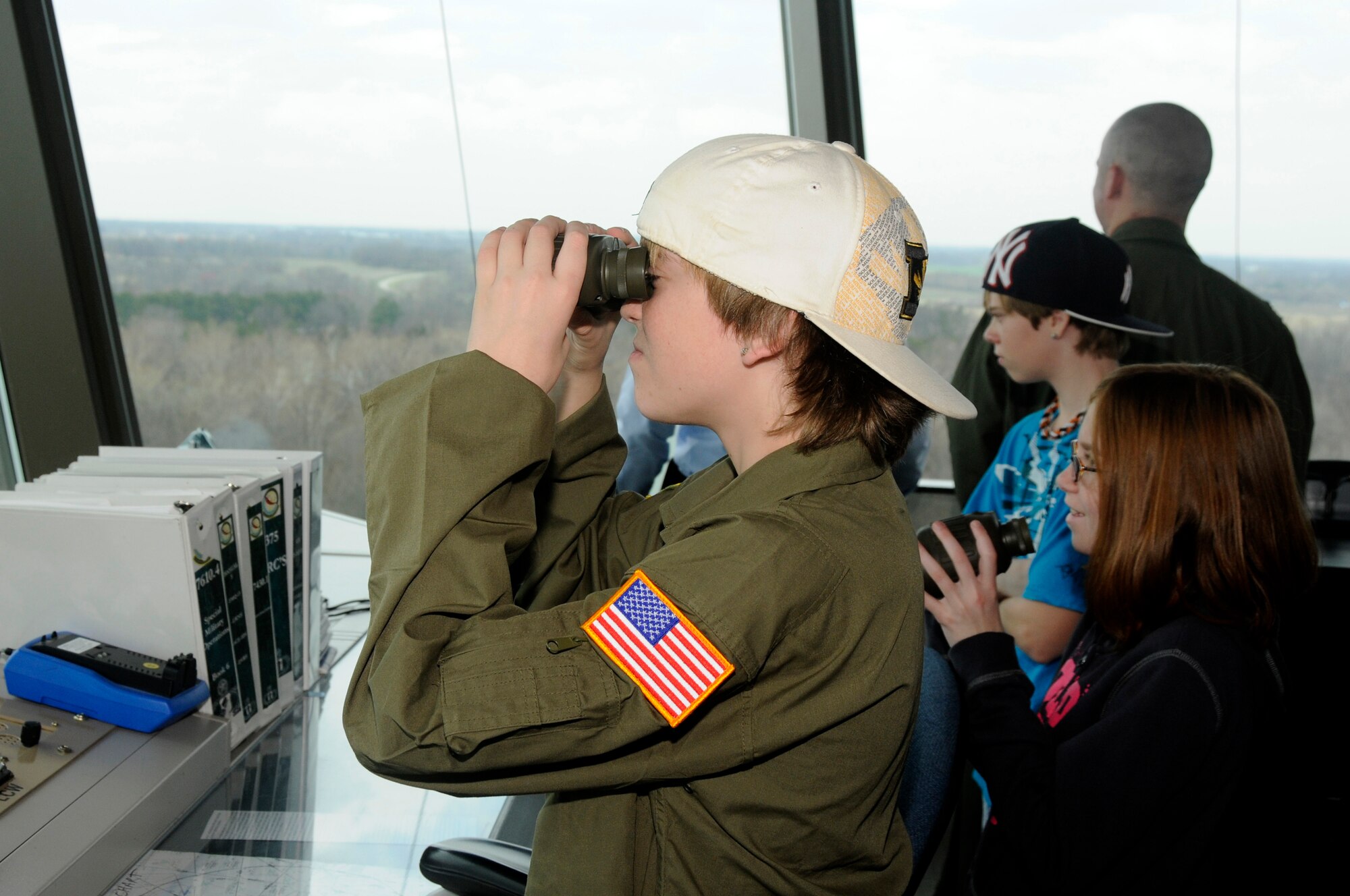 Hunter Bozaich looks out across Scott Air Force Base, Ill. from the control tower during his visit for the Pilot for a Day program, March 21, 2011. Hunter, who is diagnosed with Cystic Fibrosis was nominated by Cardinal Glennon Children's Medical Center to come to Scott and be a pilot for a day. His day consisted of multiple events and tours to include a C-40 Static, a military working dog demonstration, tower tour, and a ride in a flight simulator. (U.S. Air Force photo/Staff Sgt. Brian J. Valencia)