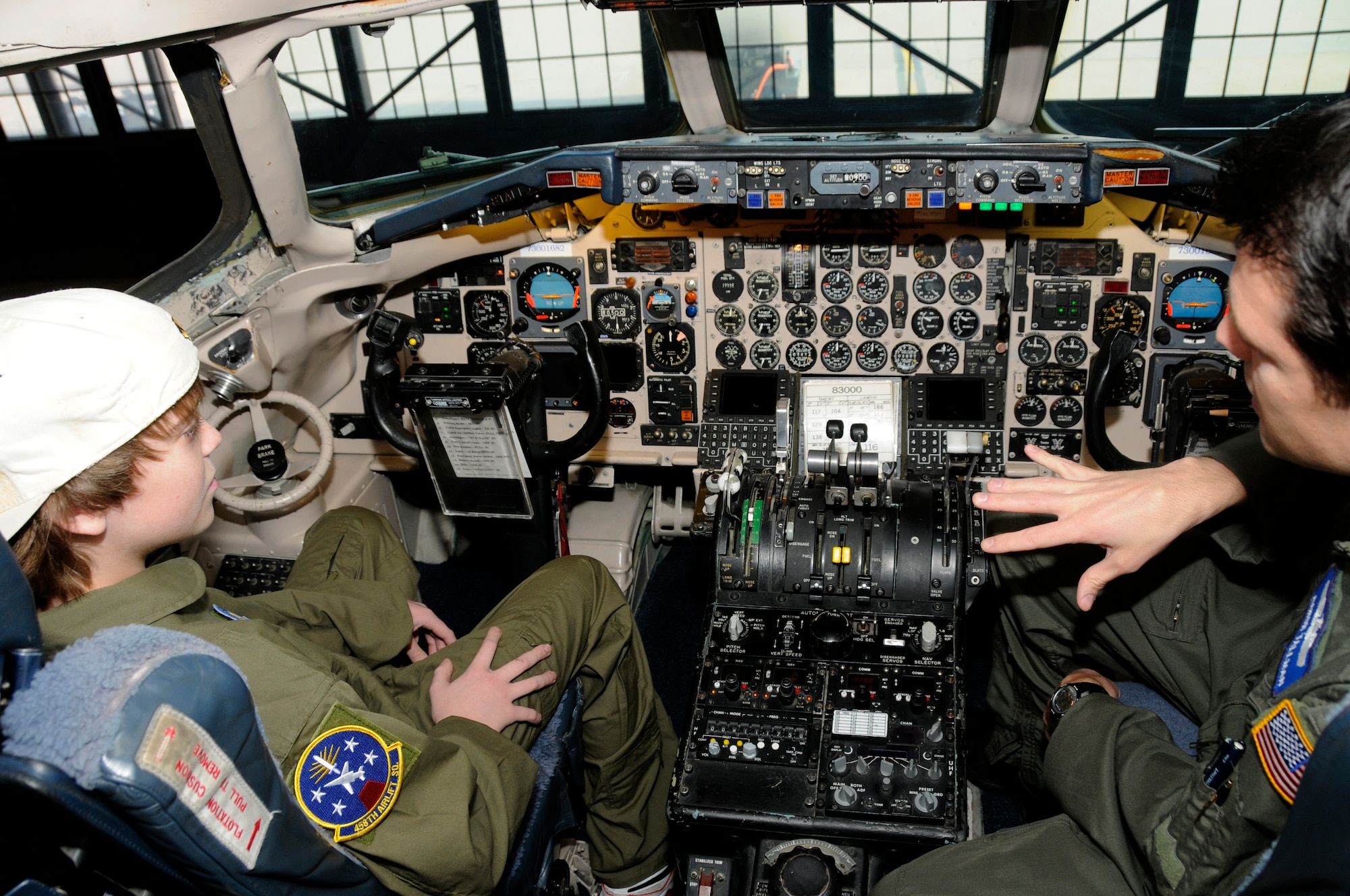 Maj. Aaron Tallman, 932nd Operations Support Flight, discusses the workings of the C-40 to Hunter Bozaich from the inside the cockpit during his visit for the Pilot for a Day program, March 21, 2011 at Scott Air Force Base, Ill. Hunter, who is diagnosed with Cystic Fibrosis was nominated by Cardinal Glennon Children's Medical Center to come to Scott and be a pilot for a day. His day consisted of multiple events and tours to include a C-40 Static, a military working dog demonstration, tower tour, and a ride in a flight simulator. (U.S. Air Force photo/Staff Sgt. Brian J. Valencia)