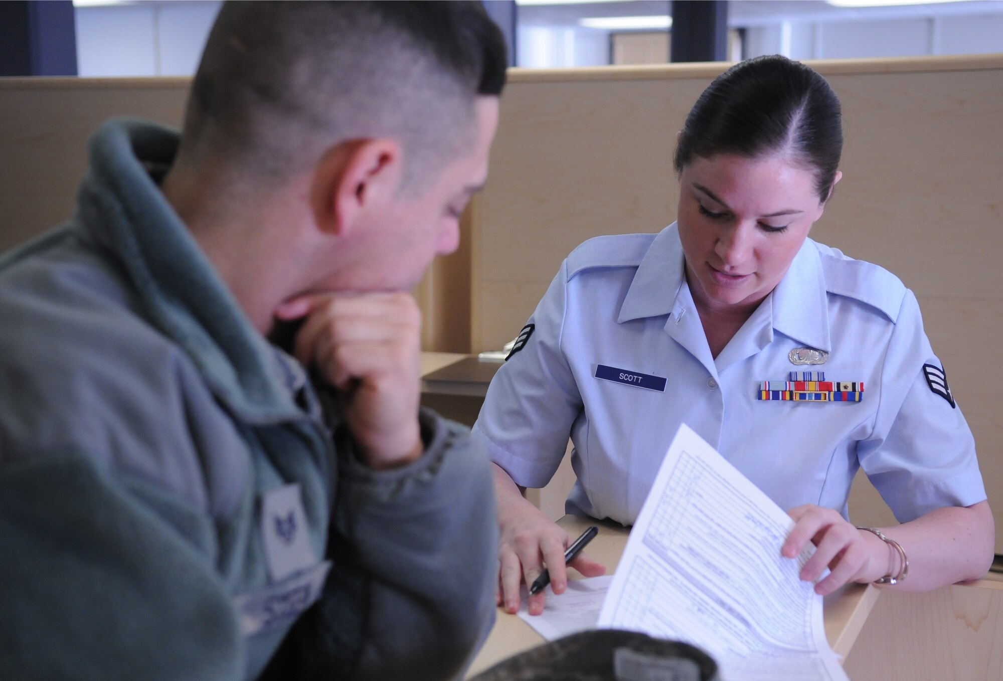 Senior Airman Jaclyn Scott assists a finance customer with a travel voucher March 21, 2011, Eielson Air Force Base, Alaska. The 354th Comptroller Squadron financial services Airmen work to ensure pay issues are handled with the best care possible so Icemen can focus on the Eielson mission. Airman Scott is a 354 CPTS customer service technician. (U.S. Air Force photo/Senior Airman Rachelle Coleman)
