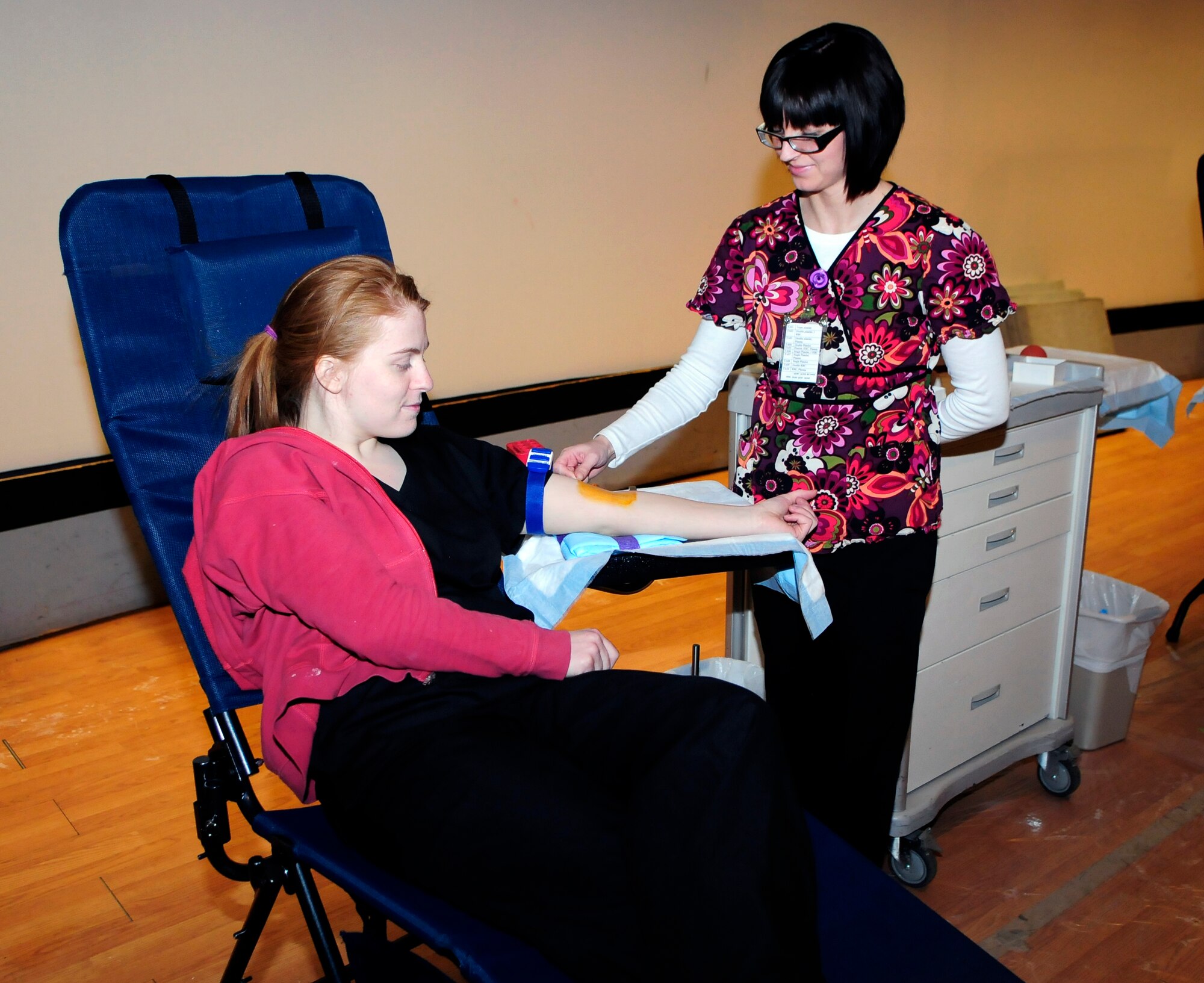 A Blood Bank of Alaska staff member practices sanitizing a coworker while awaiting donors March 16, 2011, Eielson Air Force Base, Alaska. The staff try to make donating convenient by screening donors, drawing blood, and completing the process in less than 30 minutes.  (U.S. Air Force photo by/Airman 1st Class Yash Rojas)