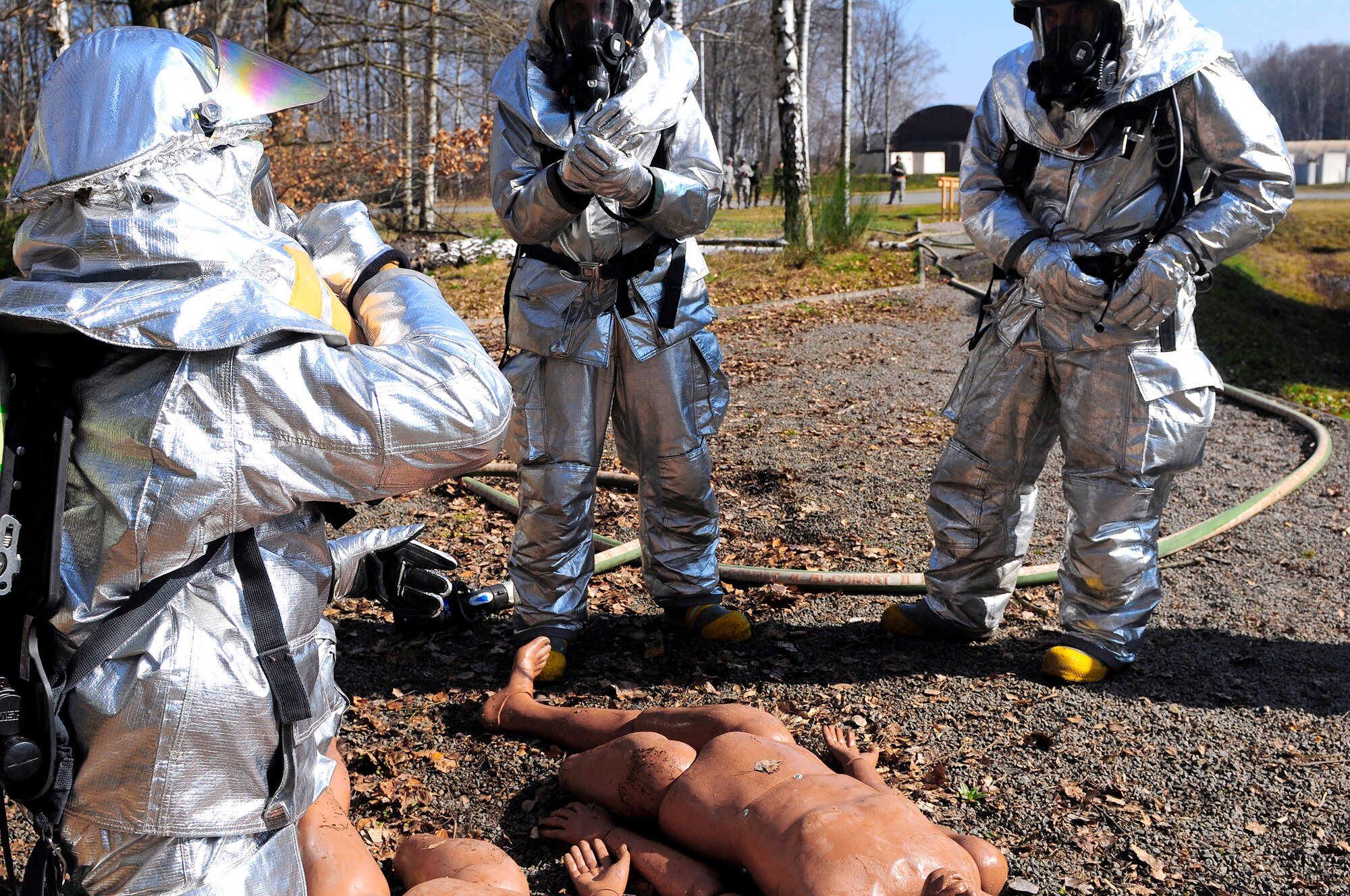 Air Force firefighters perform a simulated "rescue" of an injured victim March 15, 2011, during Silver Flag at Ramstein Air Base, Germany. The exercise consisted of several simulated scenarios that included victim rescue and uncontained fires. (U.S. Air Force photo/Airman 1st Class Brea Miller) 