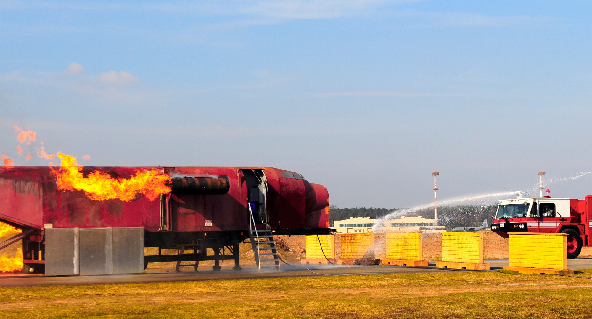 Air Force firefighters douse a simulated engine fire March 15, 2011, during Silver Flag at Ramstein Air Base, Germany. (U.S. Air Force photo/Airman 1st Class Brea Miller)