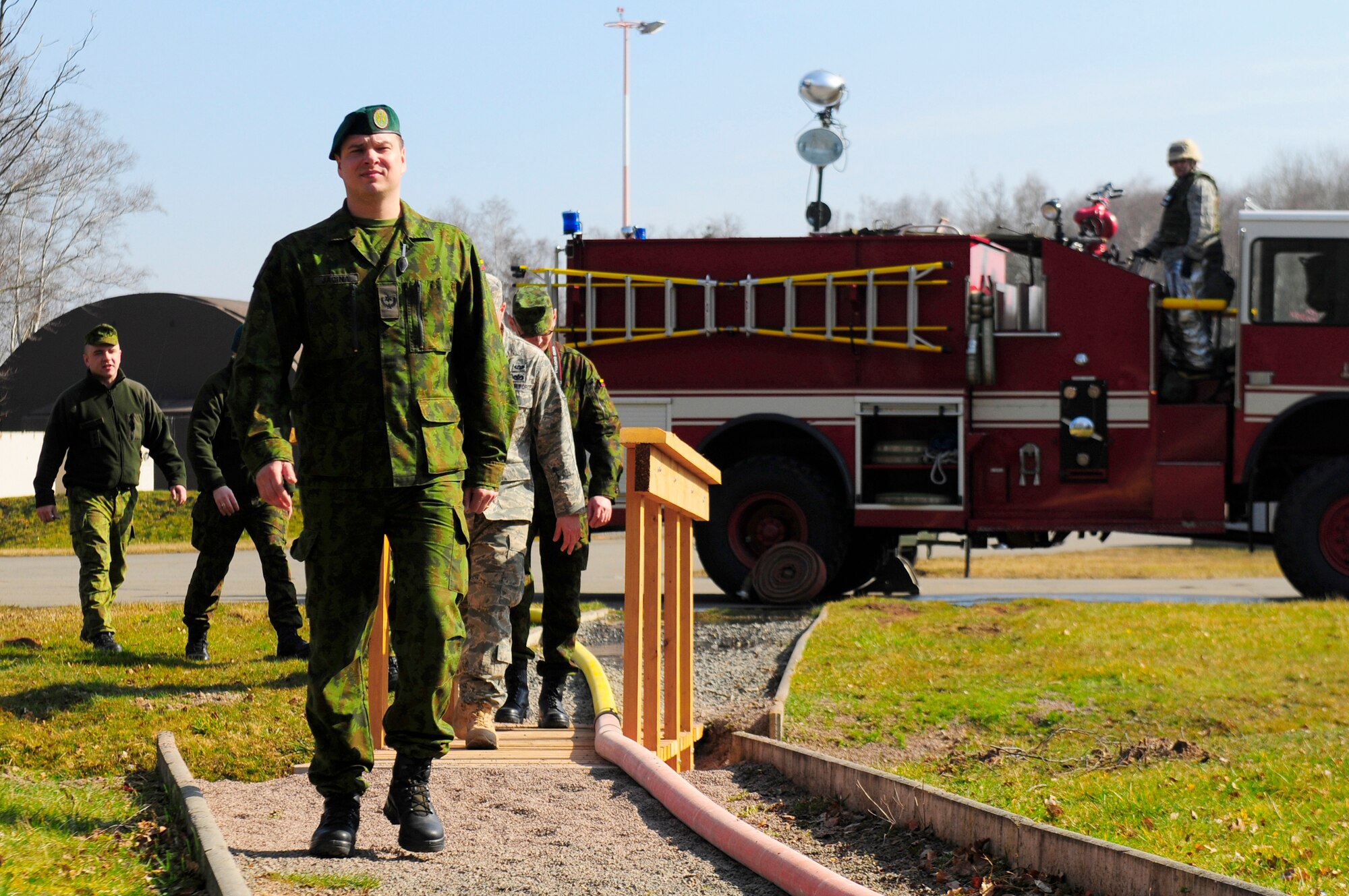 Lithuanian air force officers approach a simulated fire drill March 15, 2011, during Silver Flag at Ramstein Air Base, Germany.  (U.S. Air Force photo/Airman 1st Class Brea Miller) 