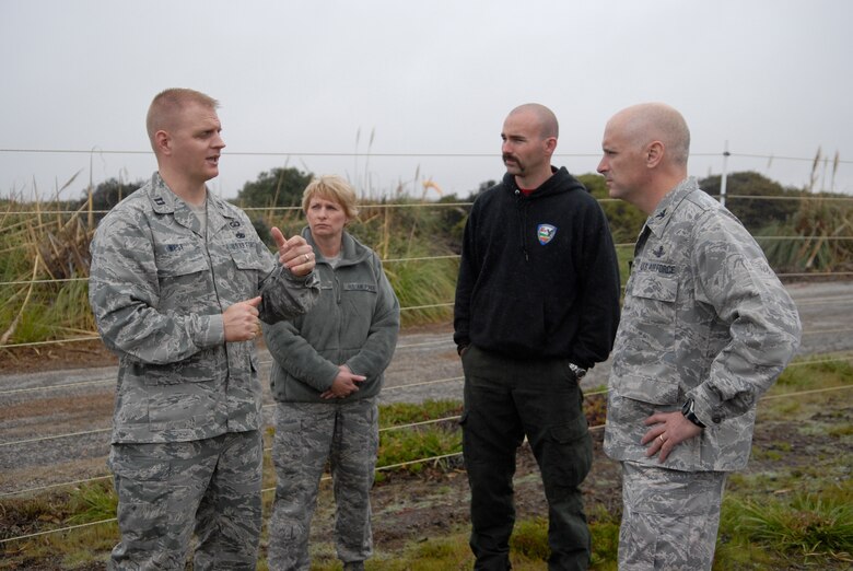 VANDENBERG AIR FORCE BASE, Calif. - Capt. Jimmy West, Airfield Operations Flight commander, Chief Master Sergeant Michelle Sobel, 30th Medical Group superintendant, Jesse Hendricks, Hot Shots superintendant, and Col. Richard Boltz, 30th Space Wing commander, discuss the team effort in acquiring and operating The Masticator here Wednesday, March 16, 2011. (U.S. Air Force photo/1st Lt. Ann Blodzinski)
