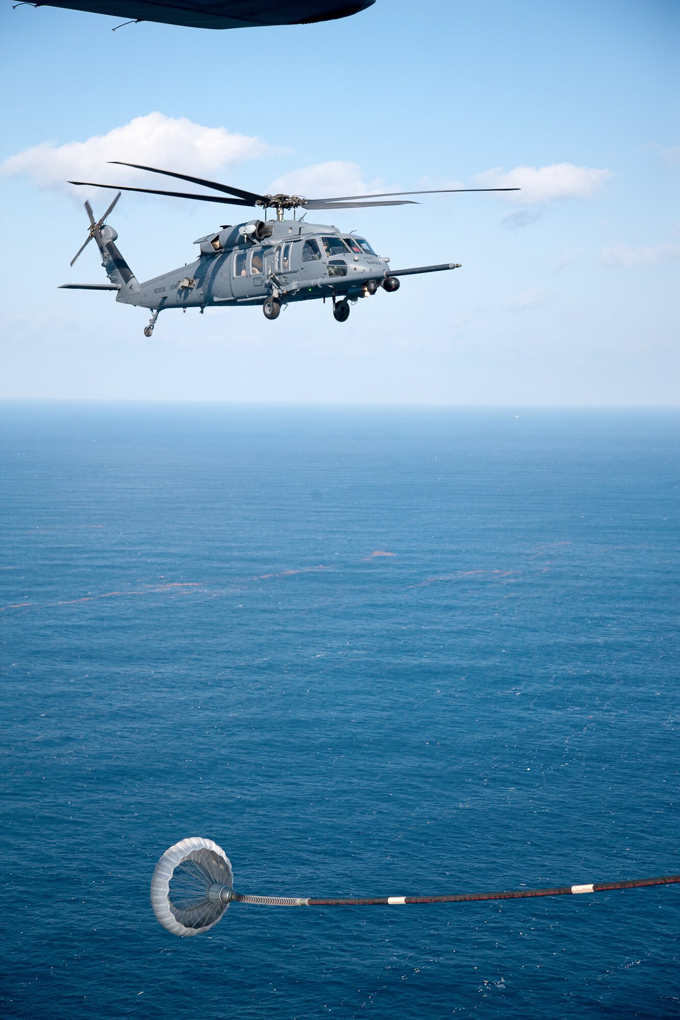 An MC-130P Combat Shadow prepares to refuel an HH-60 Pave Hawk helicopter March 18, 2011, above the Pacific Ocean. The refueling missions are in support of humanitarian relief operations after an earthquake and subsequent tsunami rocked Northeastern Japan. (U.S. Air Force photo/Osakabe Yasuo) 