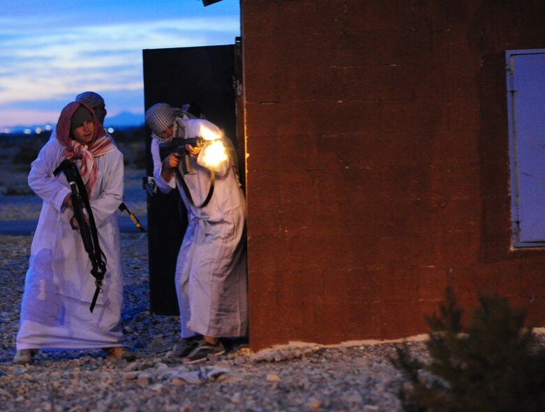NEVADA TEST AND TRAINING RANGE, Nev.-- Hostile local nationals from the village of al-Burqua, ambush an integrated American-British foot patrol March 16, 2011, during DESERT EAGLE. Although the friendly forces won the battle, they did receive injuries and had to treat them. (U.S. Air Force photo/Senior Airman Stephanie Mancha)(RELEASED)