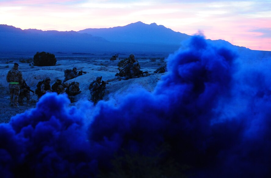 NEVADA TEST AND TRAINING RANGE, Nev. -- Friendly forces retreat to higher grounds after being ambushed on a foot patrol by hostile local nationals in the village of al-Burqua March 16, 2011. More than 250 American and British Airmen worked in unison to protect Al Zubya Air Base against a series of simulated hostile threats during the Desert Eagle exercise. (U.S. Air Force photo/Senior Airman Stephanie Mancha)