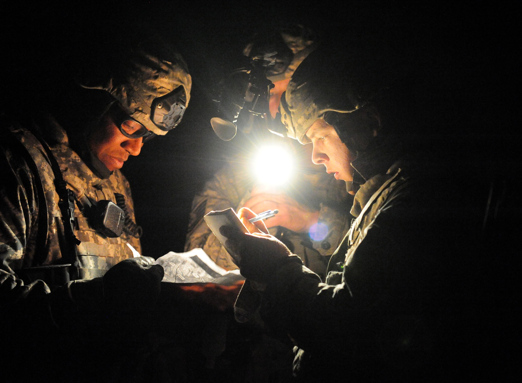 NEVADA TEST AND TRAINING RANGE, Nev.-- Members of the 822nd Base Defense Squadron write down a description of weapons found in a cache March 15, 2011. This first-ever DESERT EAGLE exercise lasted 54 consecutive hours, during which more than 250 American and British Airmen worked in unison to protect Al Zubya Air Base against a series of hostile threats. (U.S. Air Force photo/Senior Airman Stephanie Mancha)(RELEASED)