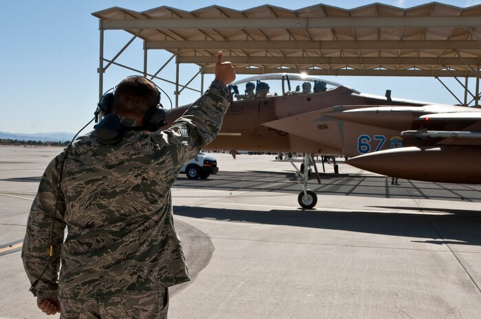 NELLIS AIR FORCE BASE, Nev. -- Staff Sgt. Eric Henriksen, 757th Aircraft Maintenance Squadron crew chief, gives a thumbs up as Gen. William M. Fraser III, commander of Air Combat Command, and Capt. Joshua Fogle, 65th Aggressor Squadron pilot, taxi out for training mission in an F-15 Eagle during Red Flag 11-3, March 9. During his weeklong visit here, General Fraser also flew on an E-3 Sentry Airborne Warning and Control System aircraft. (U.S. Air Force photo/Tech. Sgt. Michael R. Holzworth)