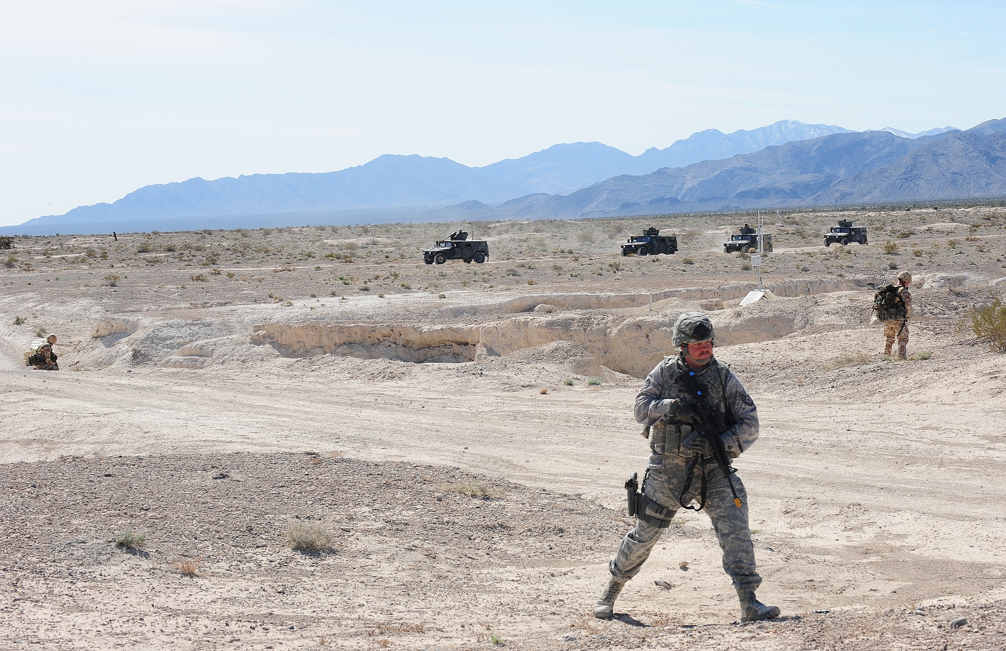 NEVADA TEST AND TRAINING RANGE, Nev.-- Members of the 822nd Base Defense Squadron and Royal Air Force Regiment perform a foot patrol March 14, 2011.  The 822nd BDS and the RAF were part of an integrated quick response team. (U.S. Air Force photo/Senior Airman Stephanie Mancha)(RELEASED)