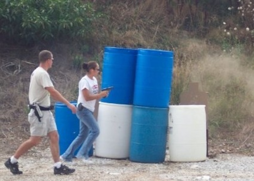 HARRISON, Ark.-- A young Airman 1st Class Meghan Hilton, 822nd Base Defense Squadron member, runs through a course in Harrison, Ark., as she practices her shooting skills in 2005. She is one of few females in the squadron and received compliments for her shooting abilities during the recent DESERT EAGLE exercise at Creech Air Force Base, Nev. (Contributed photo) (RELEASED)