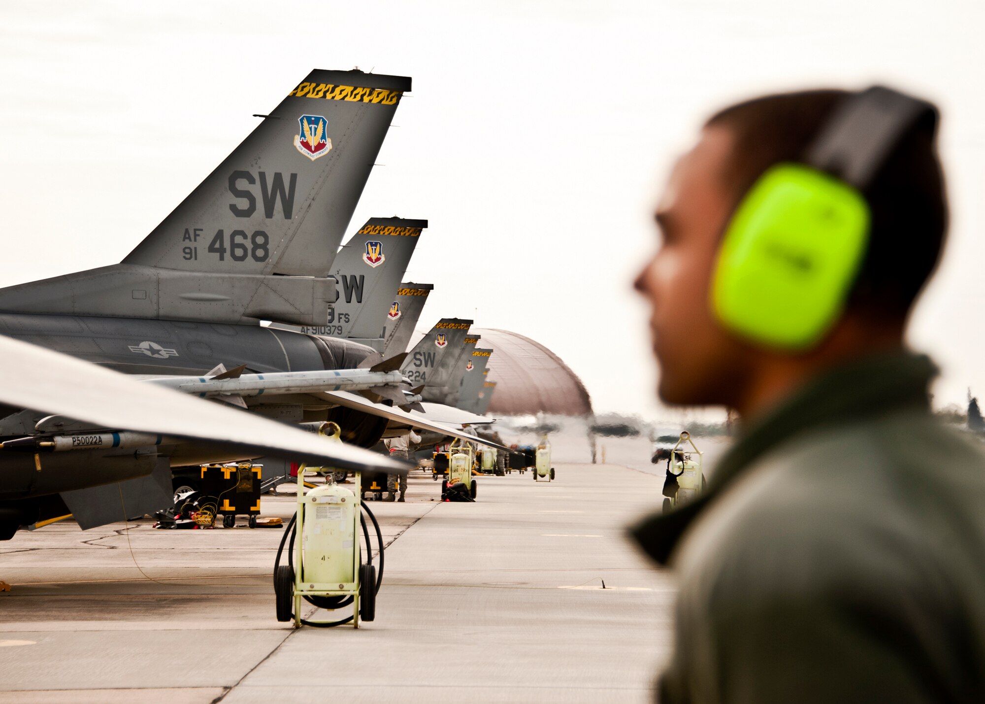 Senior Airman Keith Tunstall, 20th Aircraft Maintenance Squadron, stands as the fire guard assistant during an F-16s flight checks March 14 at Eglin Air Force Base, Fla.   More than 10 F-16s from the 20th Fighter Wing were on hand to participate in the air-to-ground weapons system evaluation program known as Combat Hammer at Eglin.  The week-long evaluation is conducted by the 86th Fighter Weapons Squadron, located here.  The squadron hosts 20 to 25 evaluations at Hill and Eglin each year, assessing weapon system performance, reliability, capabilities, and limitations in realistic combat scenarios against representative real-world targets.  (U.S. Air Force photo/Samuel King Jr.)