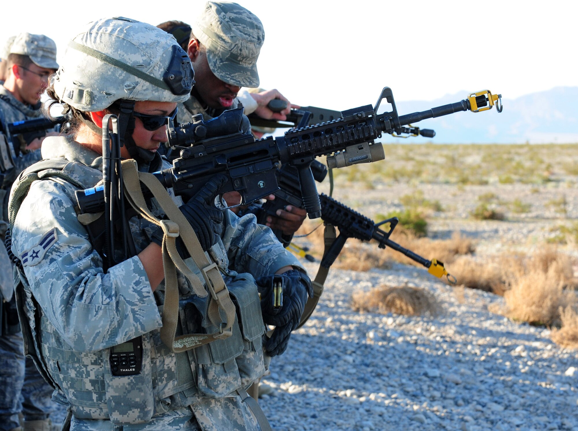 NEVADA TEST AND TRAINING RANGE, Nev.-- Airman 1st Class Meghan Hilton, 822nd Base Defense Squadron member, checks her gun during the first-ever DESERT EAGLE held from March 14 to 16, 2011. Airman Hilton started shooting at the age of 7 and hopes to become an Air Force Office of Special Investigations officer. (U.S. Air Force photo/Senior Airman Stephanie Mancha) (RELEASED)