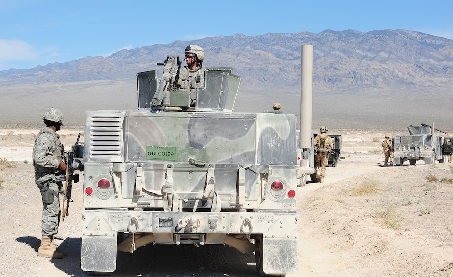 NEVADA TEST AND TRAINING RANGE, Nev.-- Airman 1st Class Meghan Hilton, 822nd Base Defense Squadron member (right), remains vigilant on a patrol during DESERT EAGLE, held March 14 to 16, 2011. Along with the .50-caliber machine gun, she is also qualified on the Mark 19 grenade launcher, 203 mm grenade launcher and Beretta M9. (U.S. Air Force photo/Senior Airman Stephanie Mancha) (RELEASED)