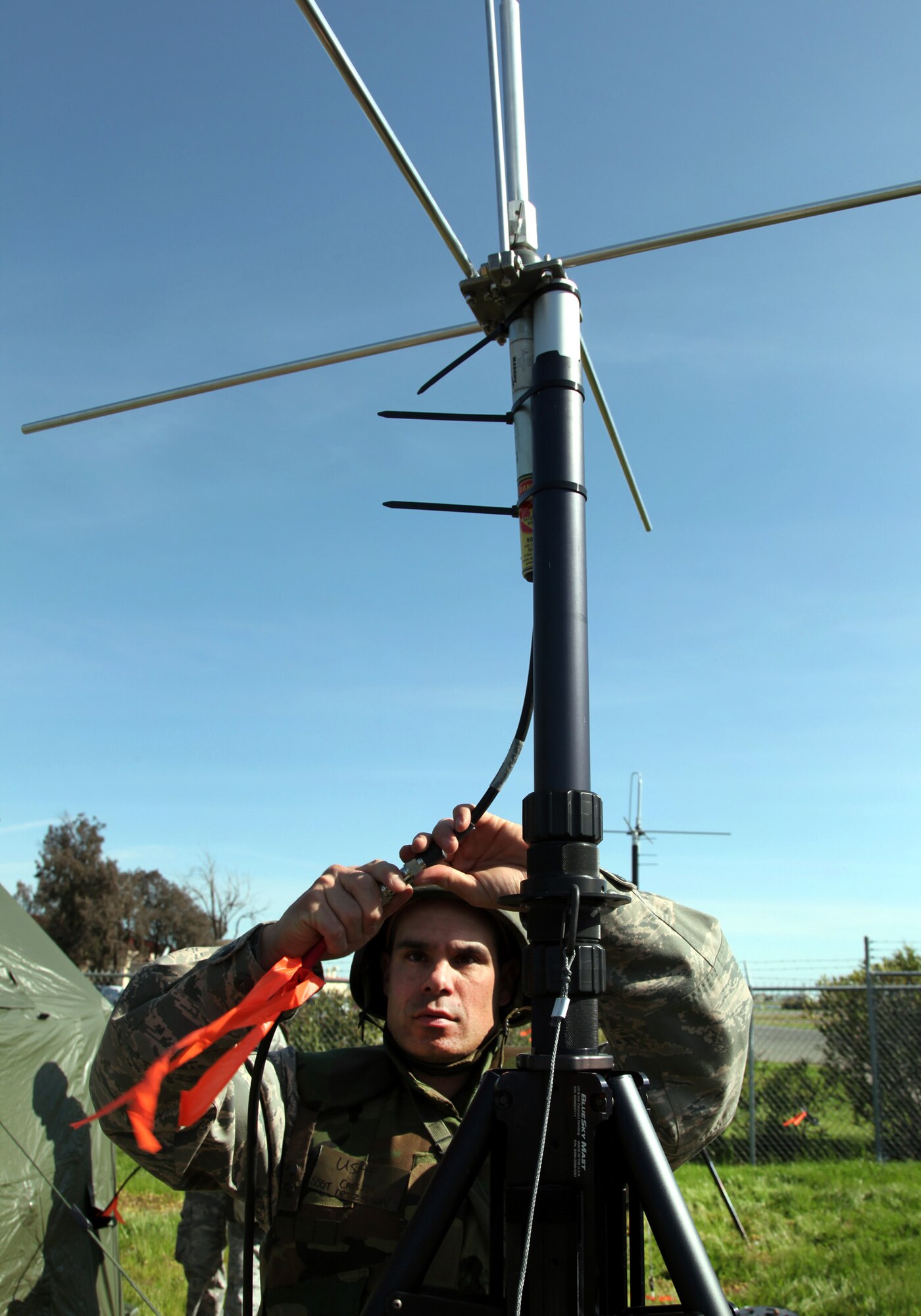 TRAVIS AIR FORCE BASE, Calif. -- Staff Sgt. Cassidy Ortiz-Nelson, radio frequency transmission specialist, attaches a wire to a radio antenna during a 23rd Combat Communications Squadron deployment and skills-training exercise on Travis Air Force Base, March 11, 2011. The 23rd CBCS is a self-contained, rapidly deployable unit capable of providing deployed commanders with voice, data and video communications in austere environments, where there is little or no infrastructure.  The squadron is an Air Force Reserve unit gained by Air Force Space Command. (U.S. Air Force photo / Lt. Col. Robert Couse-Baker)