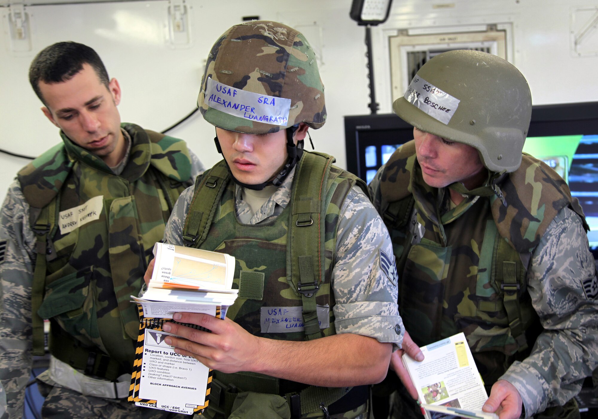 TRAVIS AIR FORCE BASE, Calif. -- Staff Sgt. Andrew Kraynek, Senior Airman Alexander Luangrath and Staff Sgt. Dalance Boschee, 23rd Combat Communications Squadron, review the Airman’s Manual during a deployment and skills-training exercise on Travis Air Force Base, March 11, 2011. The 23rd CBCS is a self-contained, rapidly deployable unit capable of providing fielded forces with voice, data and video communications in austere environments, where there is little or no infrastructure.  The squadron is an Air Force Reserve unit gained by Air Force Space Command. (U.S. Air Force photo / Lt. Col. Robert Couse-Baker)