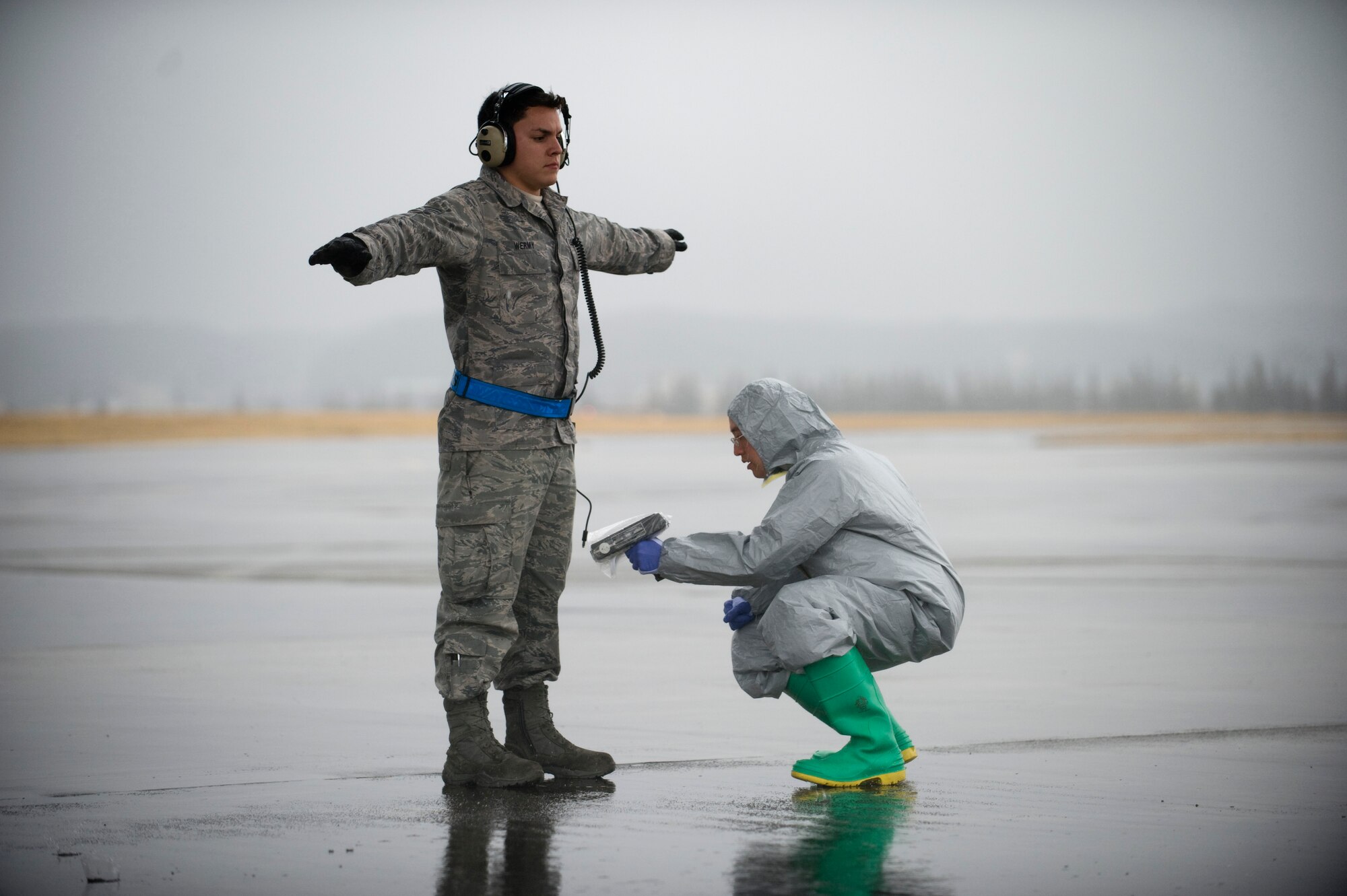 YOKOTA AIR BASE, Japan -- Senior Airman Daniel Burdick, 18th Aerospace Medicine Squadron, uses a AMD 300 radiation survey meter to scan Staff Sgt. Aaron Wermy, 374 Aircraft Maintenance Squadron, March 21. The ADM 300 is used to scan aircraft and personnel for possible presence of radiation exposure.  (U.S. Air Force photo/Staff Sgt. Jonathan Steffen)