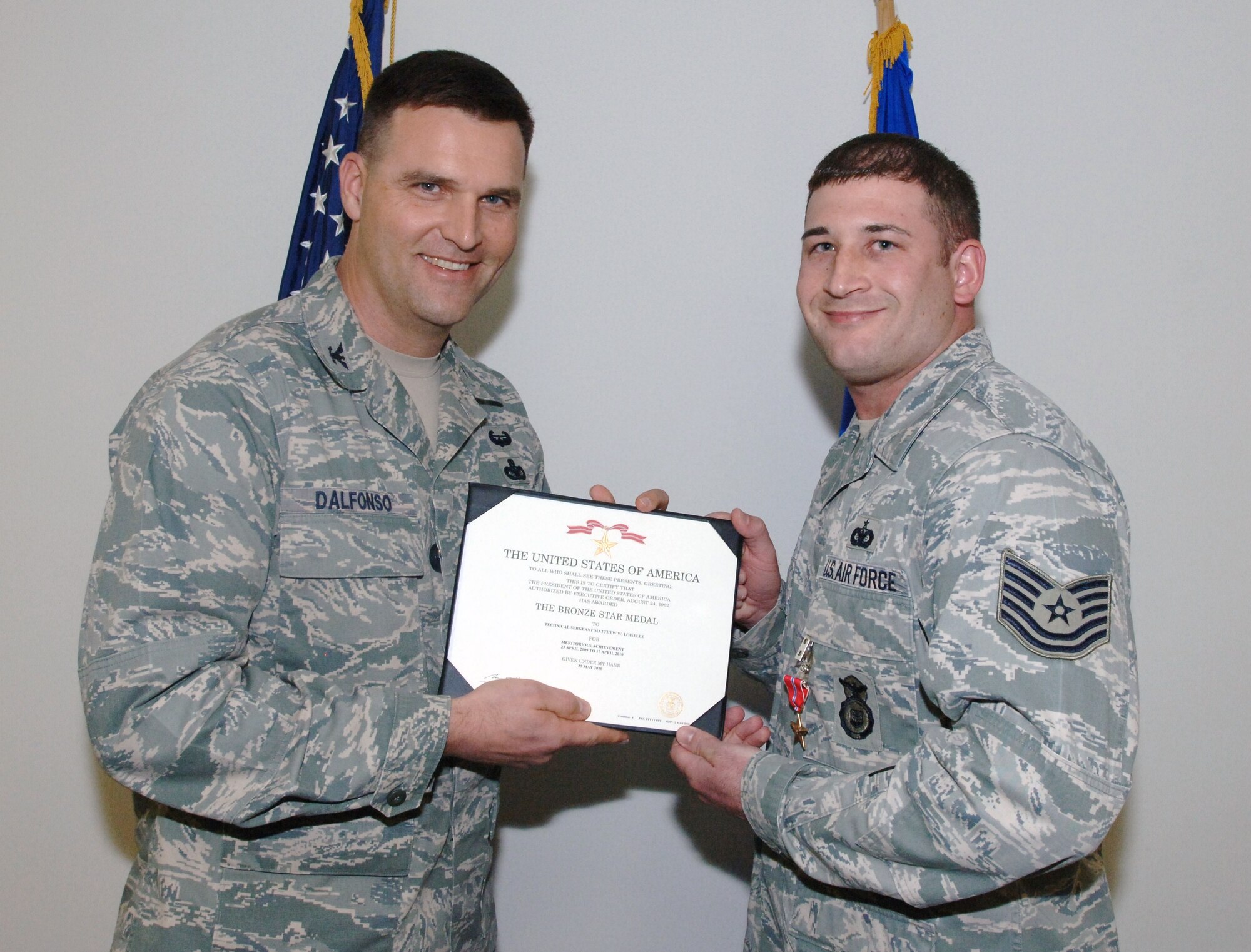 Col. Kenneth J. D’Alfonso, 633d Mission Support Group commander, presents the Bronze Star Medal and citation  to Tech. Sgt. Matthew Loiselle, 633d Security Forces Squadron, at Herron Hall on Langley Air Force Base, Va., March 18, 2011. Sergeant Loiselle received the honor for meritorious achievement as a personal security advisor for Headquarters United States Forces-Iraq’s Air Component Coordination Element while deployed to Camp Victory, Iraq from April 2009 to April 2010. While deployed, he planned and led more than 300 red zone convoy missions throughout the Baghdad area with a 100 percent success rate and successfully provided security for 275 key leadership engagements. (U.S. Air Force photo by Airman 1st Class Jason J. Brown/RELEASED)