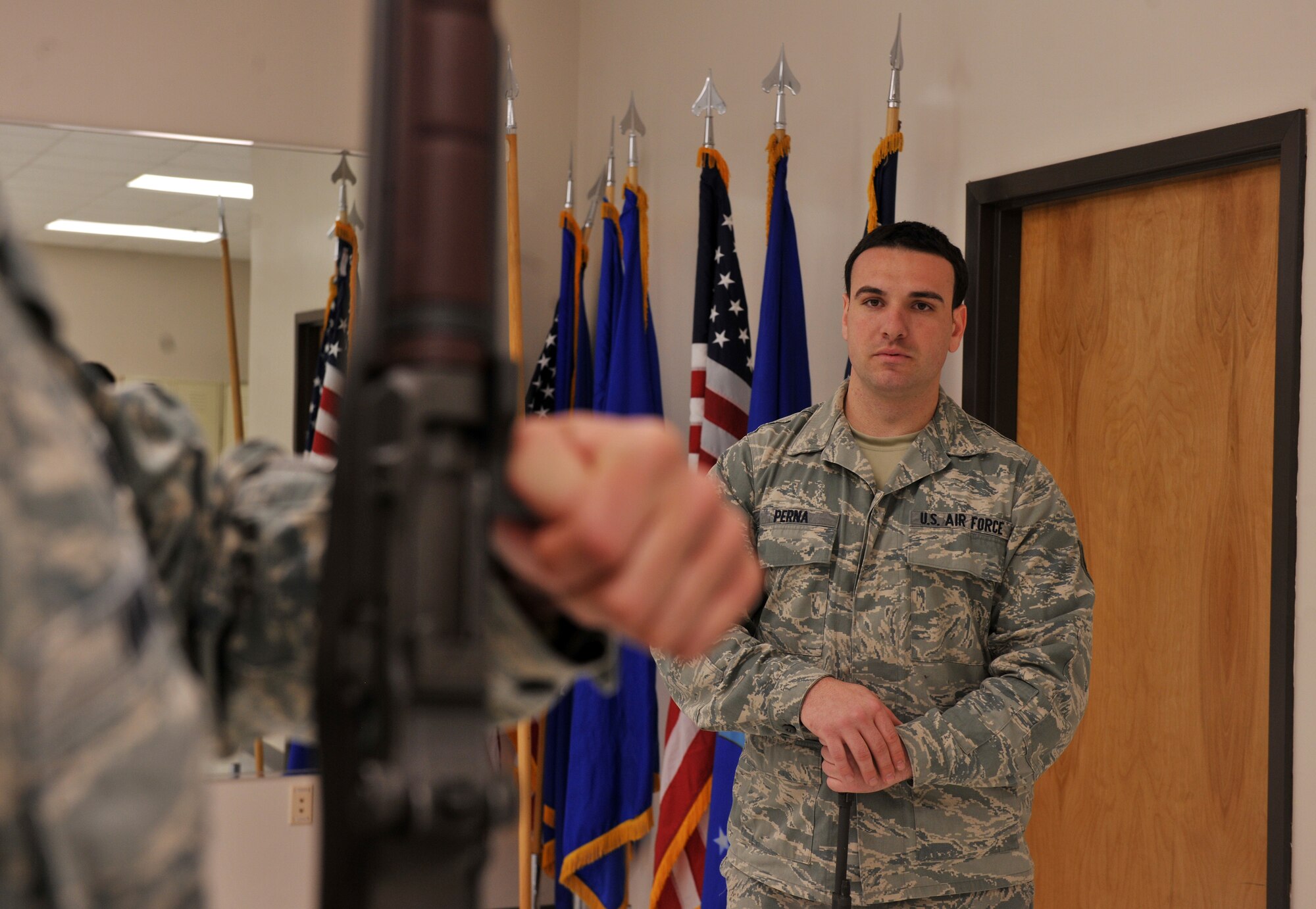 MOODY AIR FORCE BASE, Ga.-- Senior Airman Cody Perna, Moody AFB Honor Guard NCO in charge, observes a trainee while he performs steps. Airman Perna just taught March 21. Airman Perna spoke of the training as “vital and the practice received through training makes our moves second nature.” (U.S. Air Force photo/Airman 1st Class Joshua Green) (RELEASED)

