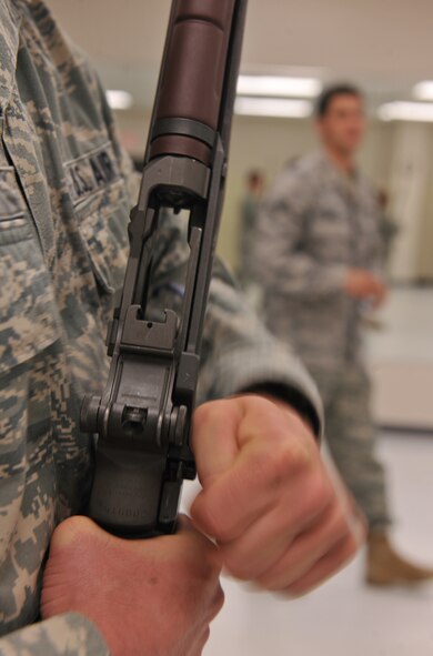 MOODY AIR FORCE BASE, Ga.-- A member from the Moody AFB Honor Guard charges his rifle during training March 21. Some of the steps learned during their training session are charging, firing and handling their rifle. (U.S. Air Force/Airman 1st Class Joshua Green) (RELEASED)

