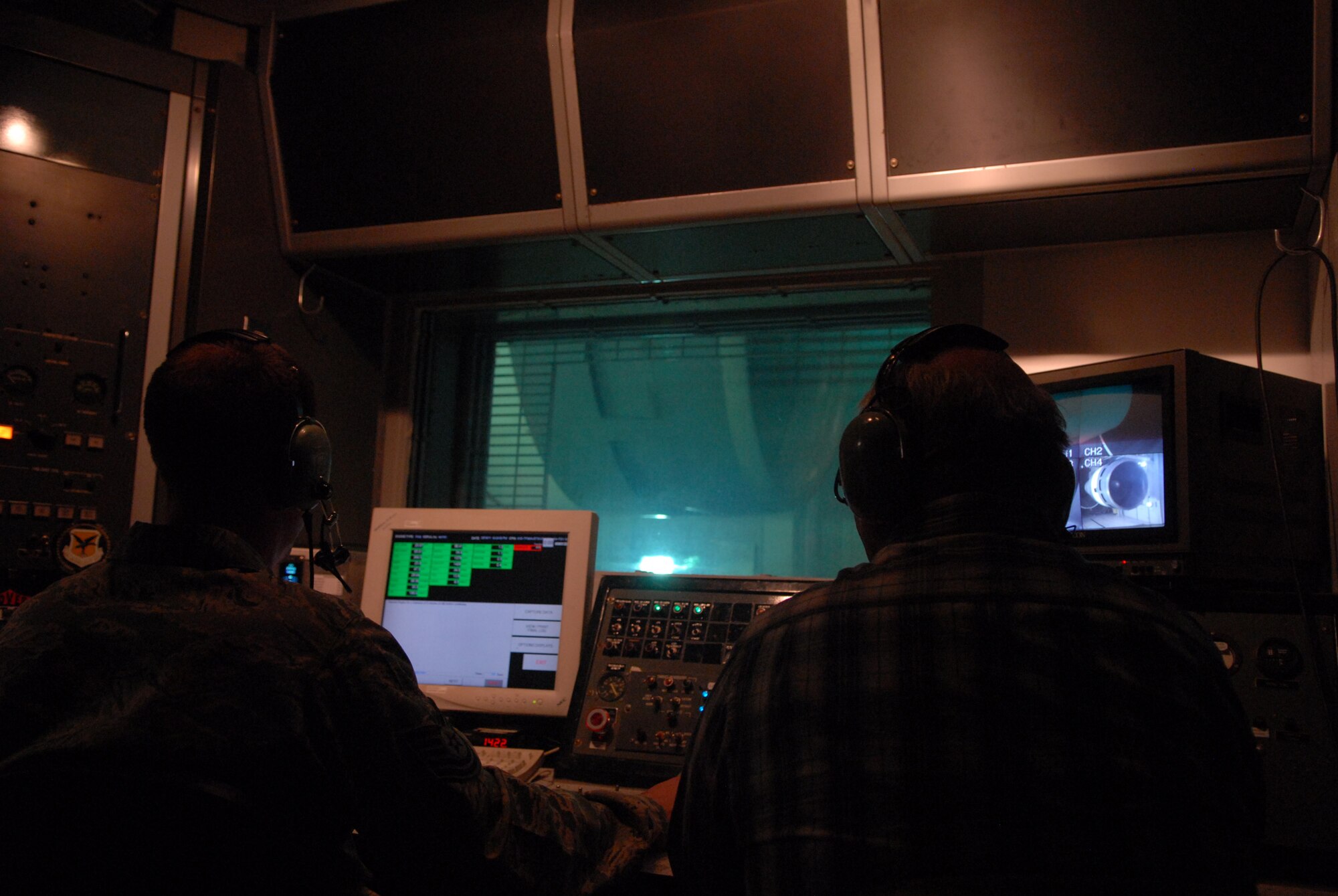 Two aerospace propulsion technicians operate the TF-39 Test Cell Center at Dover Air Force Base, Del. March 16, 2011. The test was conducted to determine the amount of decibels exiting the building. Once the level of sound is determined, the building will be upgraded so only acceptable levels of noise exiting the building. (U.S. Air Force photo by Airman 1st Class Jacob Morgan)