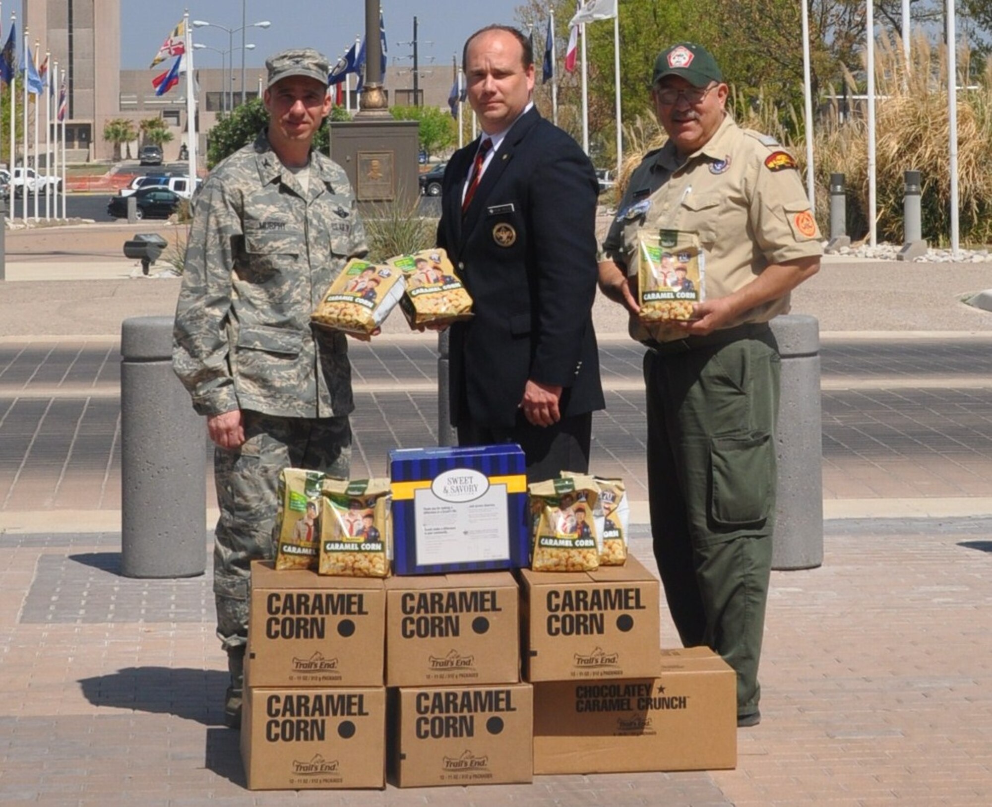 LAUGHLIN AIR FORCE BASE, Texas - - Col. Thomas Murphy receives boxes of donated popcorn from two Boy Scout leaders, Rick Reeve, scout executive for Concho Valley Council Boy Scouts, and Gerardo Martinez, senior district executive, who  donated popcorn here on Thursday to show their support for Laughlin’s deployed Airmen.   