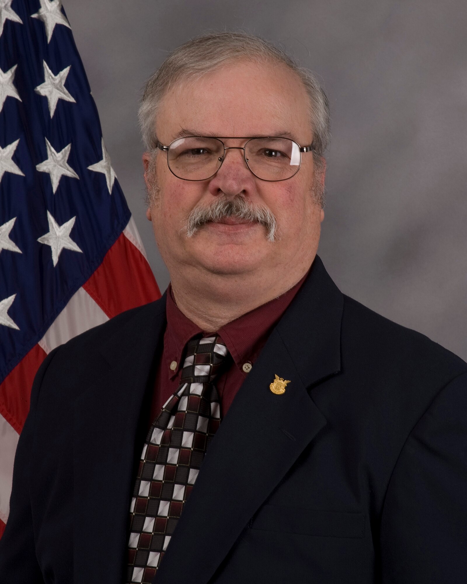 Alan Dutton, 512th Force Support Squadron, retires in a ceremony March 31 at the Air Mobility Command Museum, Dover Air Force Base, Del. Mr. Dutton, a network administrator, was assigned to the 512th Airlift Wing before unit members began using computers. 