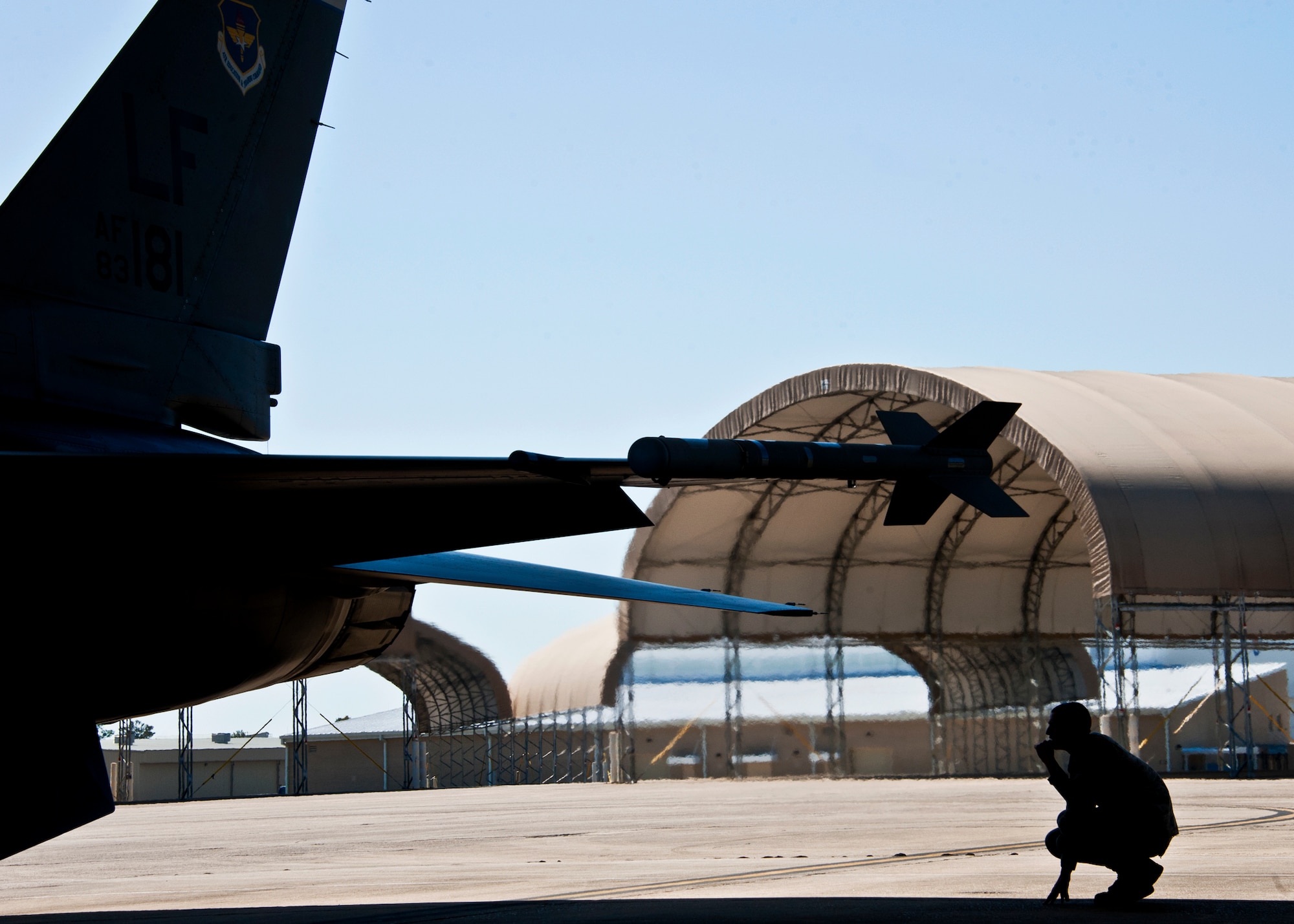 Airman 1st Class Andrew Merriman, 56th Aircraft Maintenance Squadron, monitors an F-16 Fighting Falcon through flight checks prior to a sortie at Eglin Air Force Base, Fla., March 18.  The F-16s were brought here to provide familiarization training to the 33rd Fighter Wing pilots prior to the arrival of the F-35 and to establish a “battle rhythm” for the 33rd flightline operations.  Currently, Marines and Air Force pilots are completing daily sorties.  (U.S. Air Force photo/Samuel King Jr.)