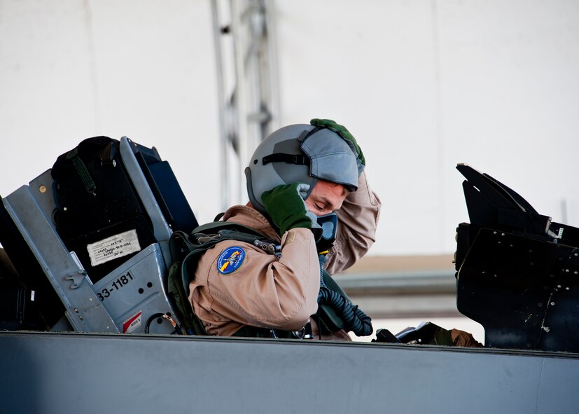 Marine Lt. Col. James Wellons, Marine Fighter Attack Training Squadron 501 commander, seals his oxygen mask to his helmet before his F-16 sortie at Eglin Air Force Base, Fla., March 18, 2011. The F-16 sorties flown by Marine pilots were the first flights for the VMFAT-501 -- the Marine squadron responsible for training on the F-35B. The flights are designed to familiarize the pilots with an aircraft similar to the F-35 as well as introduce them to the airspace and flightline operations. (U.S. Air Force photo/Samuel King Jr.) 