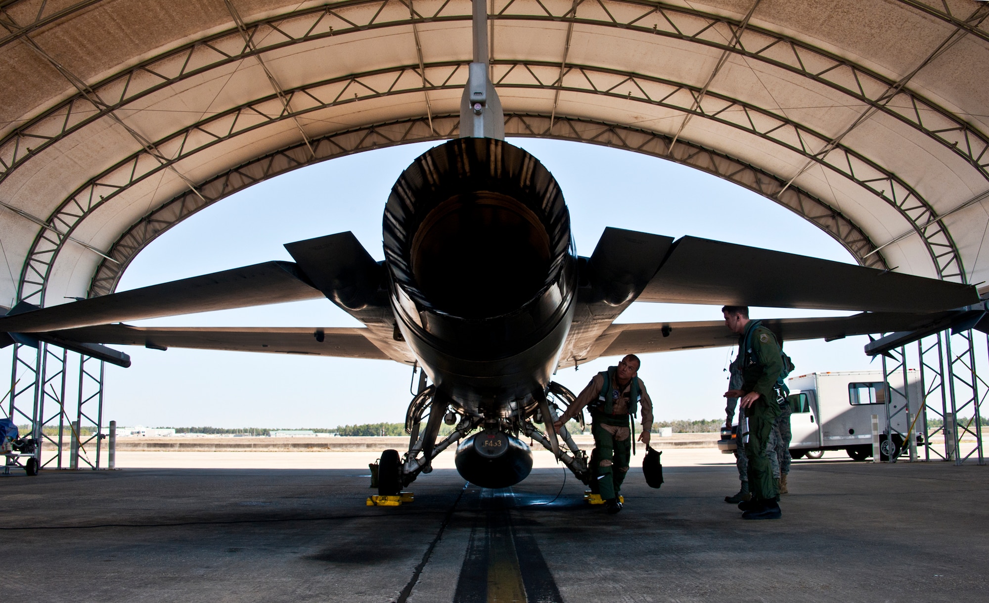 Marine Lt. Col. James Wellons, Marine Fighter Attack Training Squadron 501 commander, inspects his aircraft prior to his sortie at Eglin Air Force Base, Fla., March 18.  The F-16 sorties flown by Marine pilots last week were the first flights for the VMFAT-501 - the Marine squadron responsible for training on the F-35B.  The flights are designed to familiarize the pilots with an aircraft similar to the F-35 as well as introduce them to the airspace and flightline operations.  (U.S. Air Force photo/Samuel King Jr.)