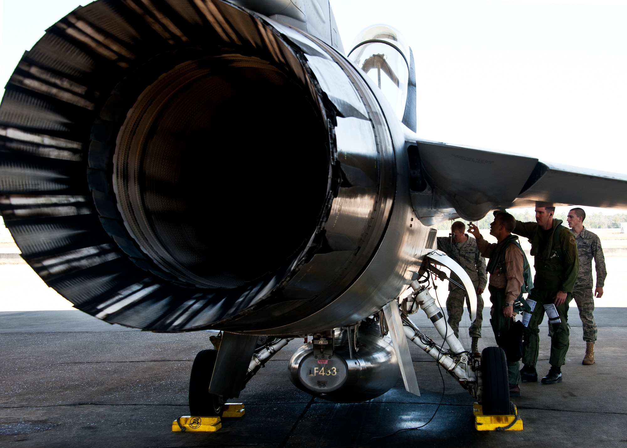 Marine Lt. Col. James Wellons, Marine Fighter Attack Training Squadron 501 commander, inspects his aircraft prior to his sortie at Eglin Air Force Base, Fla., March 18.  The F-16 sorties flown by Marine pilots last week were the first flights for the VMFAT-501 - the Marine squadron responsible for training on the F-35B.  The flights are designed to familiarize the pilots with an aircraft similar to the F-35 as well as introduce them to the airspace and flightline operations.  (U.S. Air Force photo/Samuel King Jr.)
