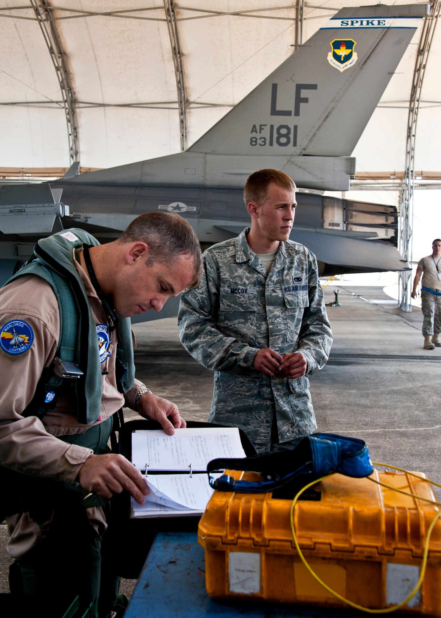 Marine Lt. Col. James Wellons, Marine Fighter Attack Training Squadron 501 commander, reviews the F-16 maintenance log book before his F-16 sortie at Eglin Air Force Base, Fla., March 18.  The F-16 sorties flown by Marine pilots last week were the first flights for the VMFAT-501 - the Marine squadron responsible for training on the F-35B.  The flights are designed to familiarize the pilots with an aircraft similar to the F-35 as well as introduce them to the airspace and flightline operations.  (U.S. Air Force photo/Samuel King Jr.)