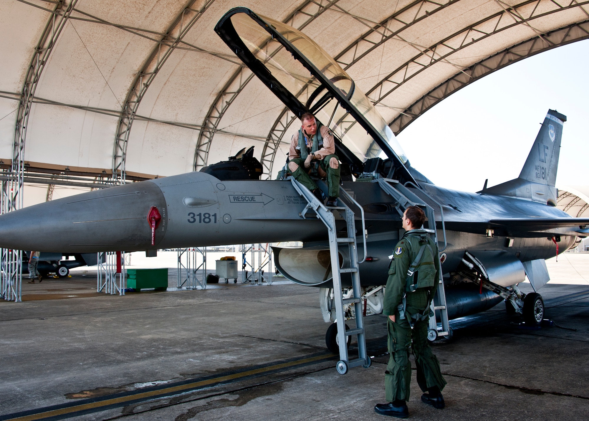 Marine Capt. Mark Noble, Marine Fighter Attack Training Squadron 501, talks about his flight with an F-16 trainer at Eglin Air Force Base, Fla., March 18.  After completing his second familiarization flight here, he was cleared to fly solo missions.  The F-16 sorties flown by Marine pilots last week were the first flights for the VMFAT-501 - the Marine squadron responsible for training on the F-35B.  The flights are designed to familiarize the pilots with an aircraft similar to the F-35 as well as introduce them to the airspace and flightline operations.  (U.S. Air Force photo/Samuel King Jr.)