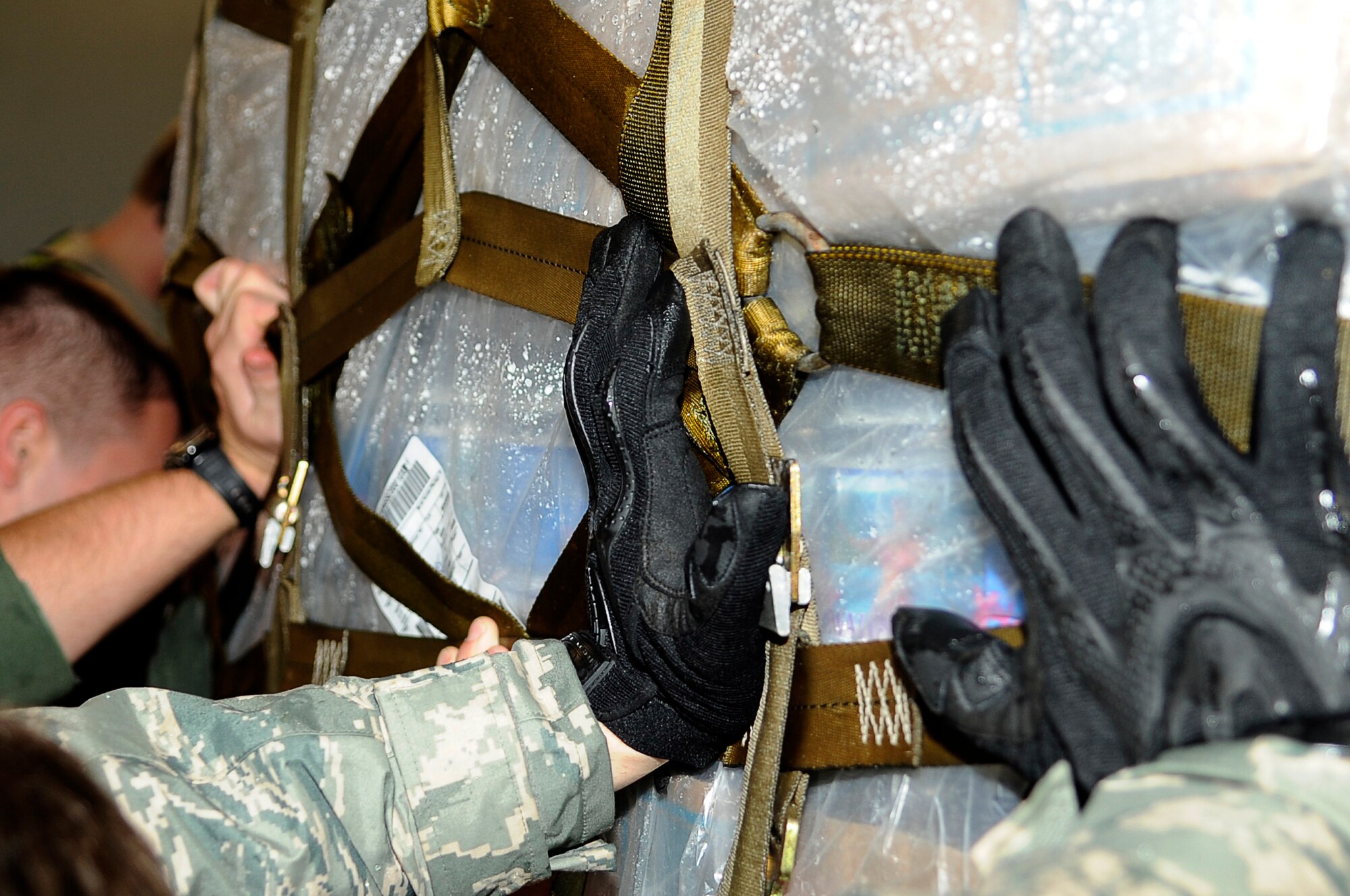 YOKOTA AIR BASE, Japan -- Airmen load a pallet of water onto a C-17 Globemaster III March 21, 2011. Crews unloaded the water and other relief items at Sendai Airport as American forces work closely with their Japanese counterparts to aid the people of Japan in the aftermath of an 8.9 earthquake, which hit Japan March 11. ?Tomodachi? is a Japanese word meaning ?friends.? (U.S. Air Force photo by/Master Sgt. Jeromy K. Cross/released) 