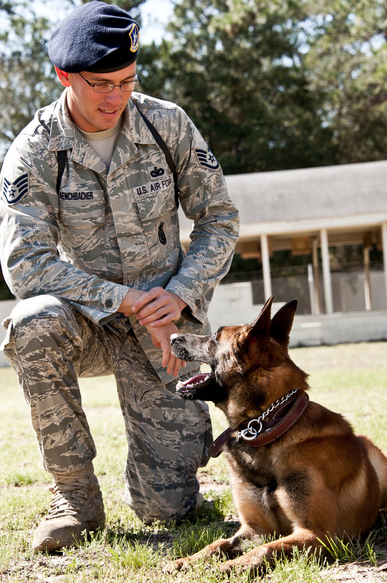 Teammates, Staff Sgt. David Aenchbacher and Rex, 96th Security Forces, smile at each other after a workout on the obstacle course at the Eglin kennel.  The team recently competed in the United States Police Canine Association regional competition for the first time.  The K-9 team was the only military team in the competition and took home second place in the novice (first year) category.  (U.S. Air Force photo/Samuel King Jr.)