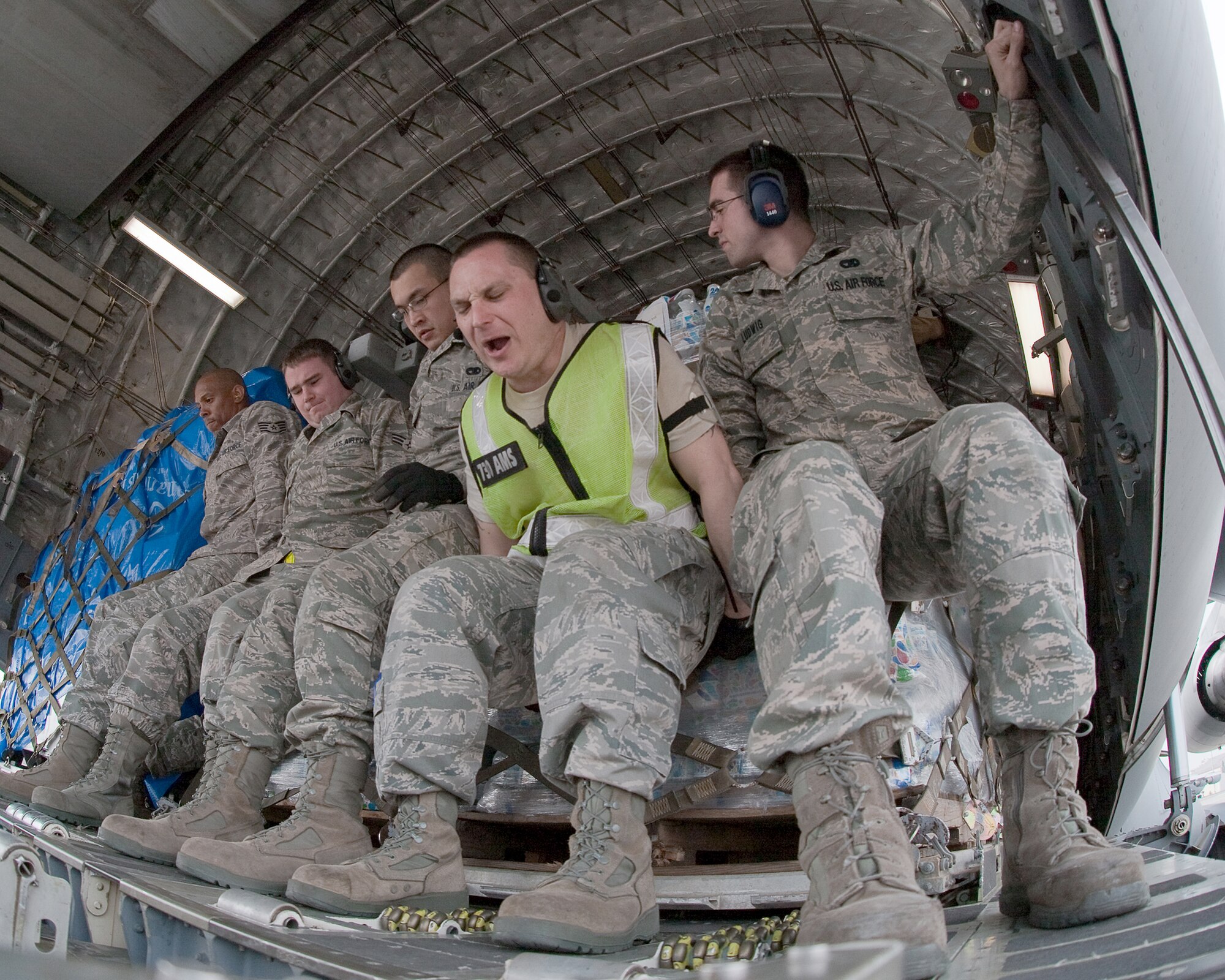 Airmen from the 730th Air Mobility Squadron load 10 pallets of food, water and blankets onto a C-17 Globemaster III March 20, 2011, at Yokota Air Base, Japan. This was the first C-17 carrying humanitarian relief supplies to land at Sendai Airport. (U.S. Air Force photo/Osakabe Yasuo) 