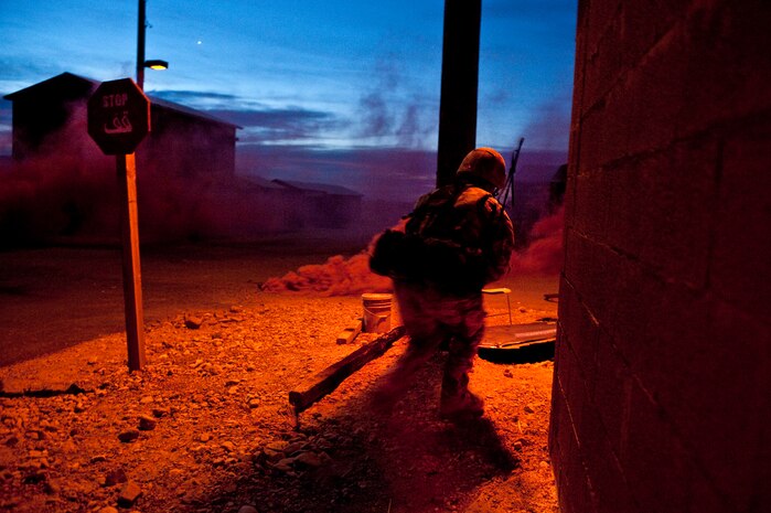 NEVADA TEST AND TRAINING RANGE -- Royal Air Force Senior Aircraftsman Chris Lott, No.1 Squadron, Regiment 4 Force Protection Wing security forces move toward cover while under attack during a field training exercise on the NTTR as part of exercise Desert Eagle March 16.  Desert Eagle is an integrated training between No. 1 Squadron, Royal Air Force Regiment and the 820th Base Defense Group from Moody Air Force Base, Ga., to improve both nations ability work together during present and future contingencies. (U.S. Air Force photo by Tech. Sgt. Michael R. Holzworth)