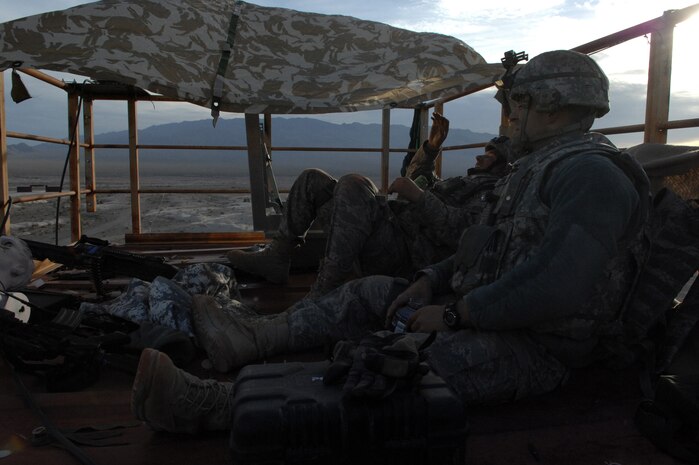 NEVADA TEST AND TRAINING RANGE -- Airman 1st Class Evvie Morgan and Michael Haffner,820th Base Defense Group security forces, rest briefly between firefights during a field training exercise at exercise Desert Eagle on the NTTR March 16. Desert Eagle is integrated training between No.1 Squadron, RAF Regiment and the 820th Base Defense Group Moody Air Force Base Ga., to improve both nations ability to work together during present and future contingencies. (U.S. Air Force photo by Airman 1st Class George Goslin)